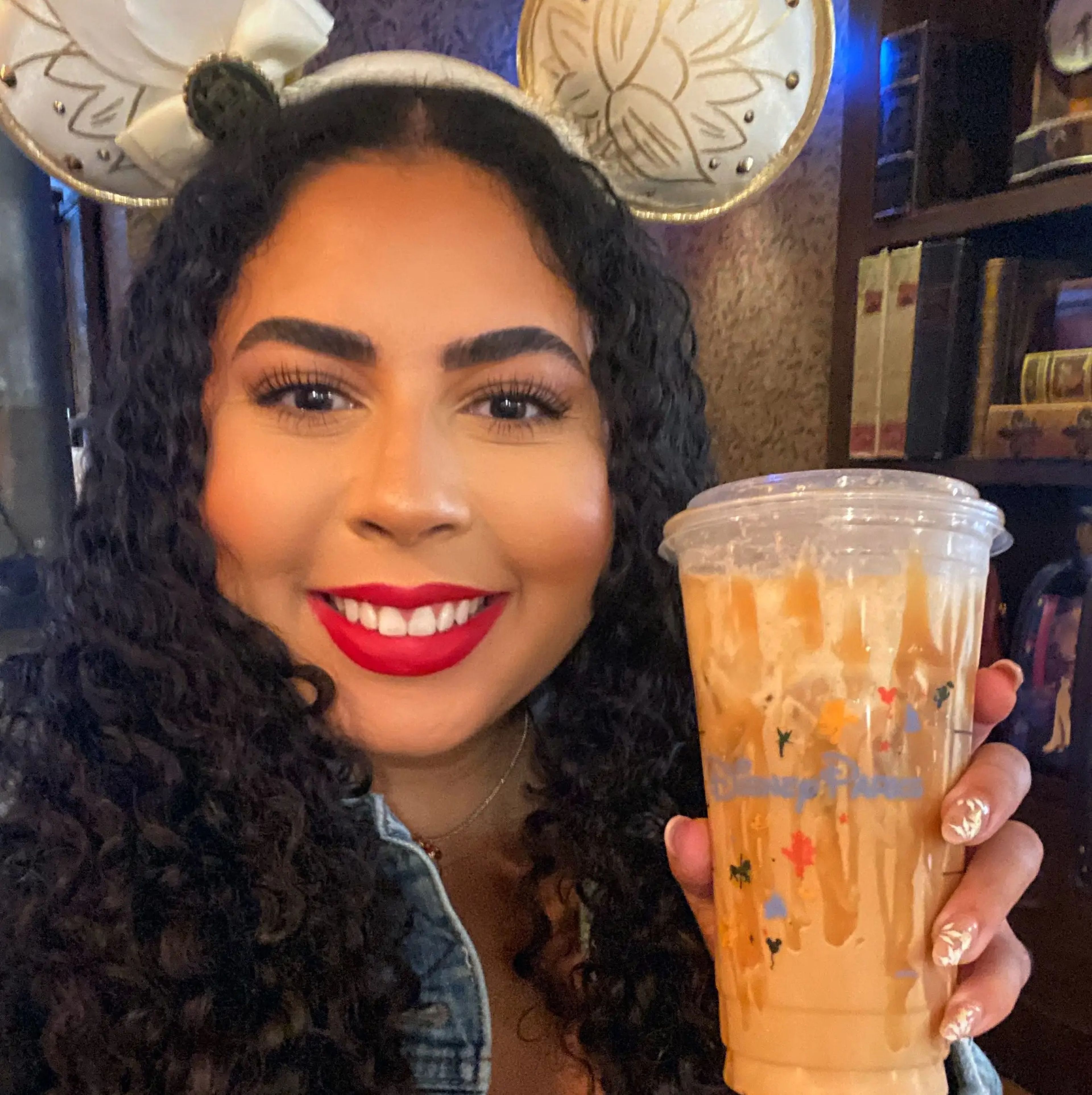 Melissa holding a Disney Parks Starbucks drink.