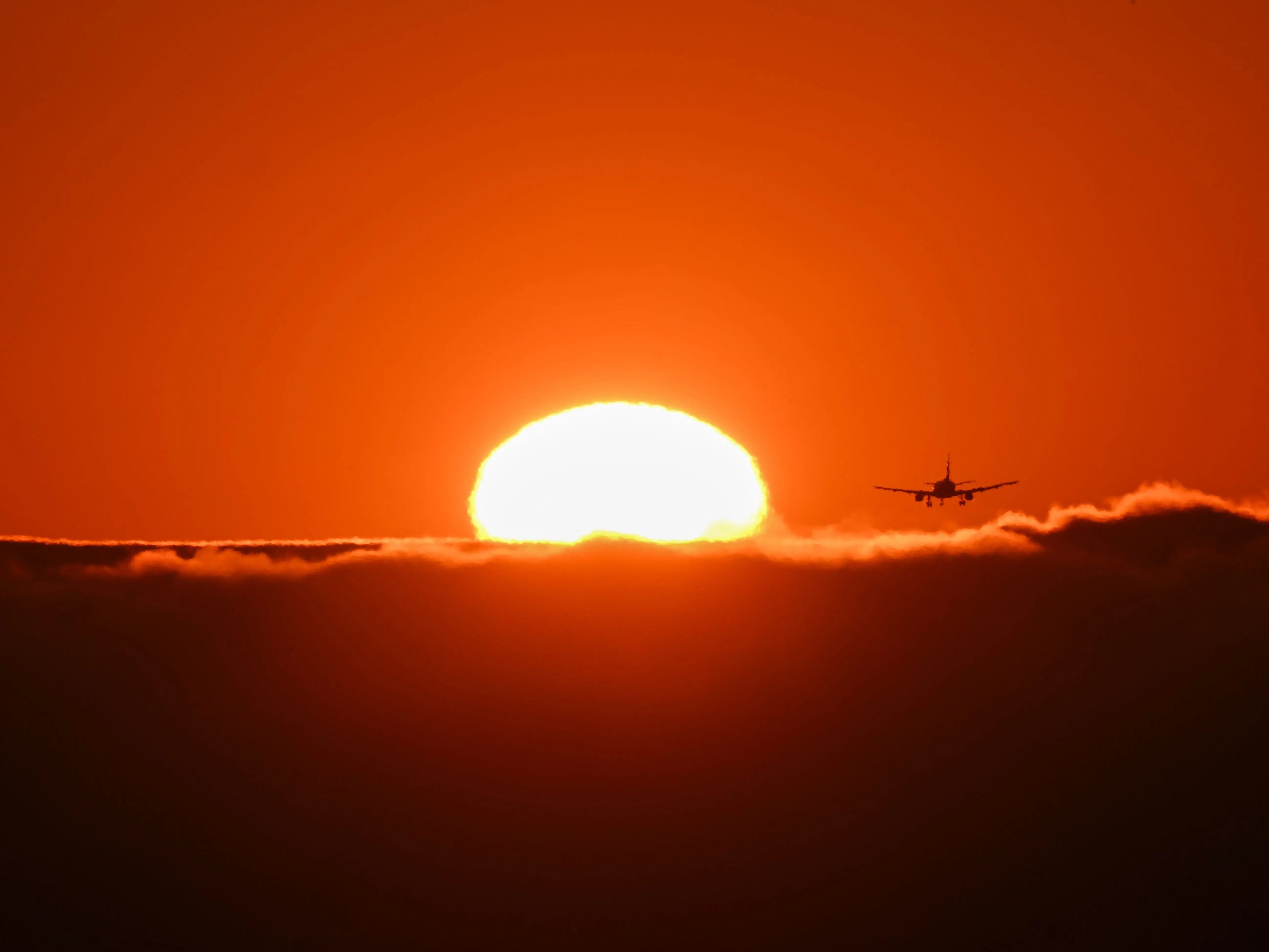 A plane lands during California's heat wave at the San Francisco International Airport.