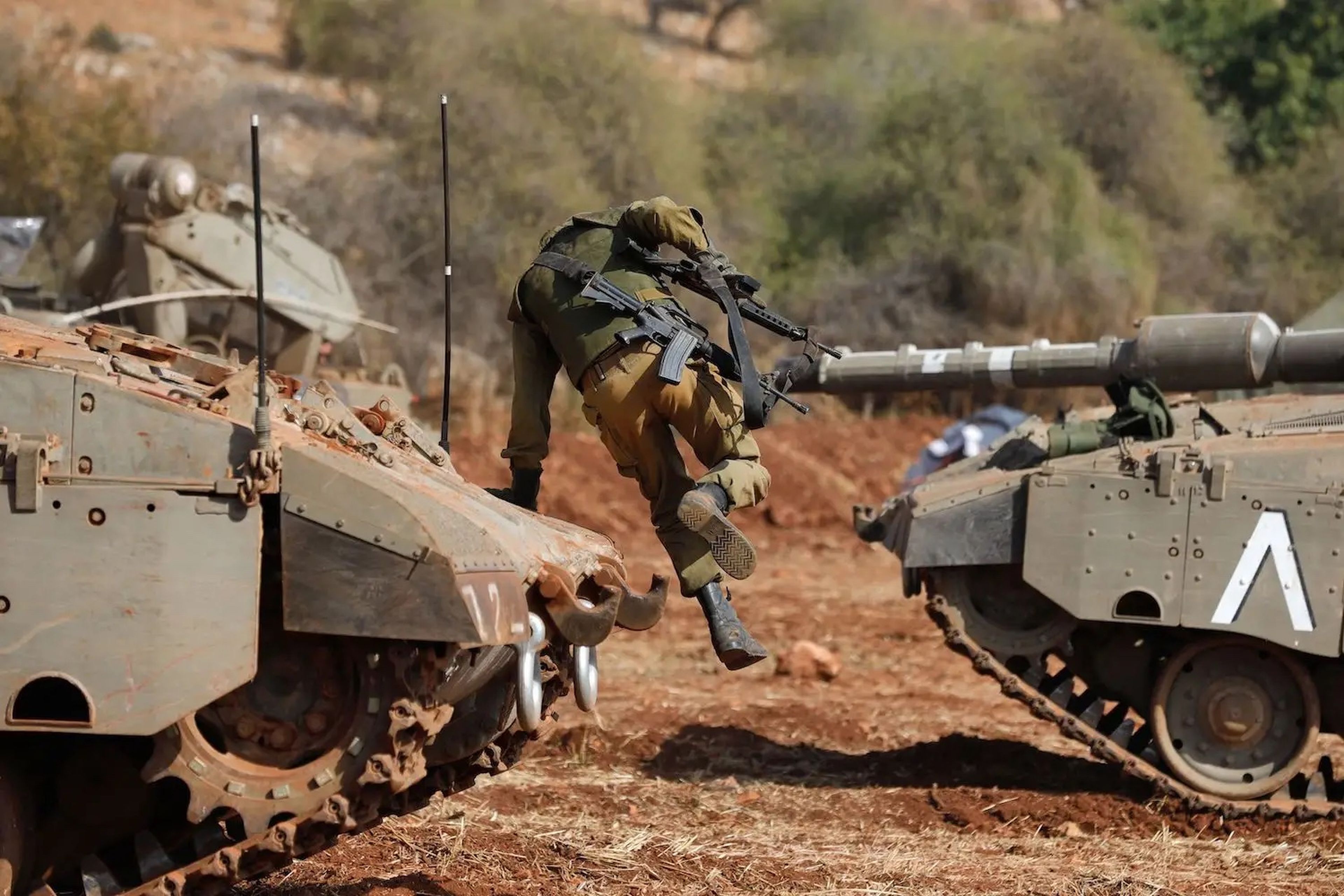 Un soldado israelí salta de un tanque Merkava durante un ejercicio militar cerca de la frontera con Líbano, en la región de la Alta Galilea, en el norte de Israel, el 24 de octubre de 2023.