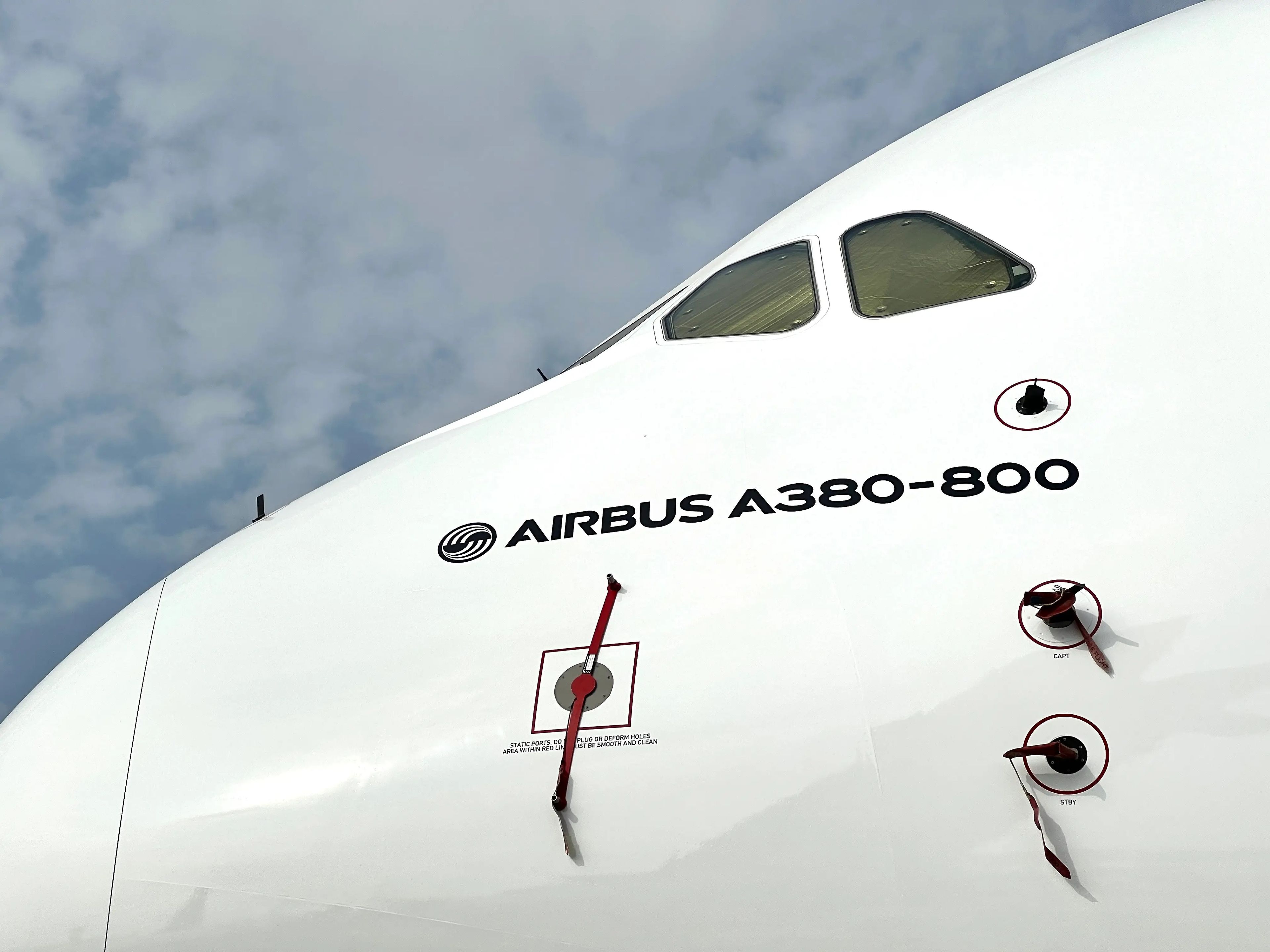 A closeup of the AIRBUS A380-800 logo underneath the cockpit of an Emirates jet at the Dubai Airshow 2023