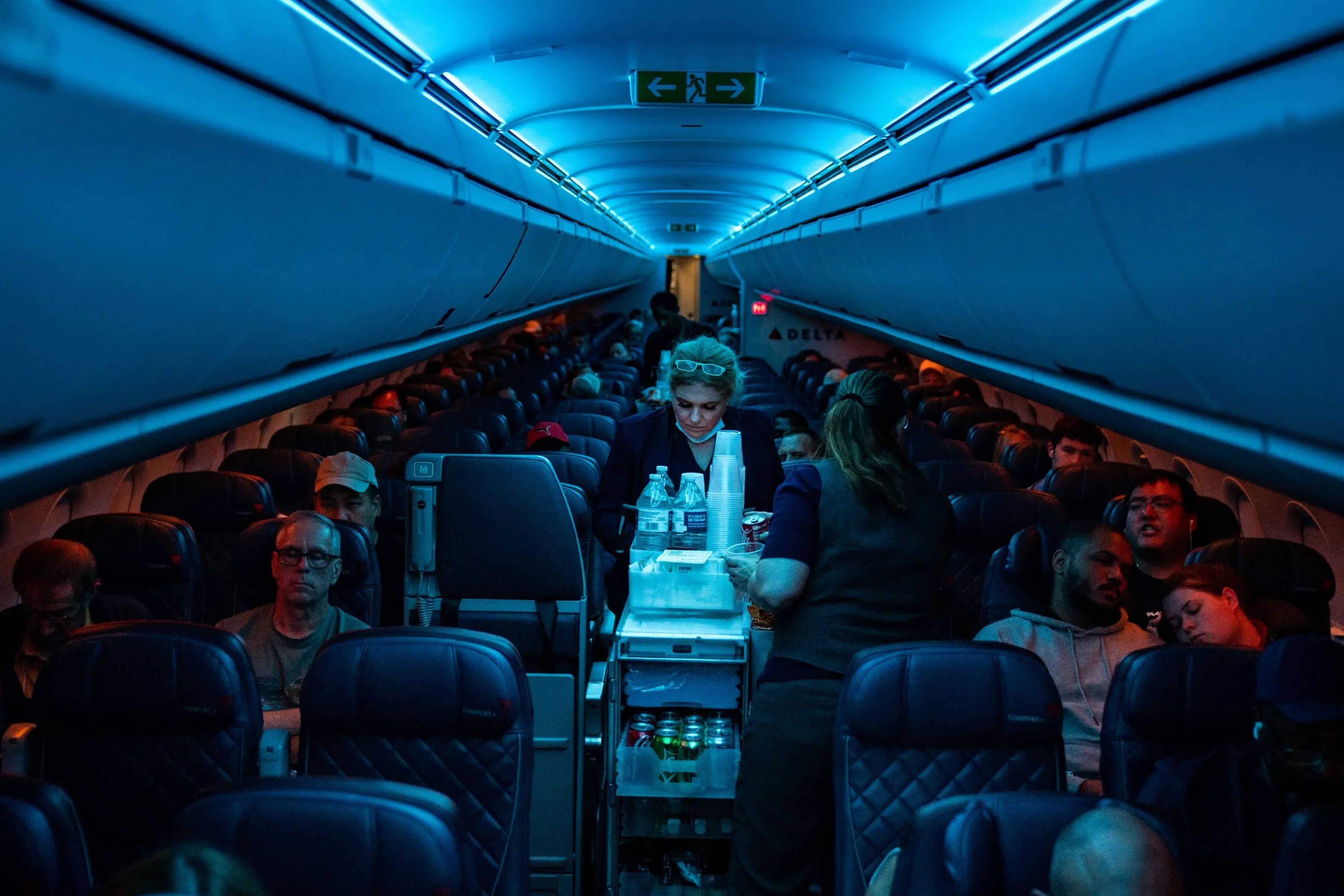 Flight attendants serve refreshments on a Delta Airlines flight.