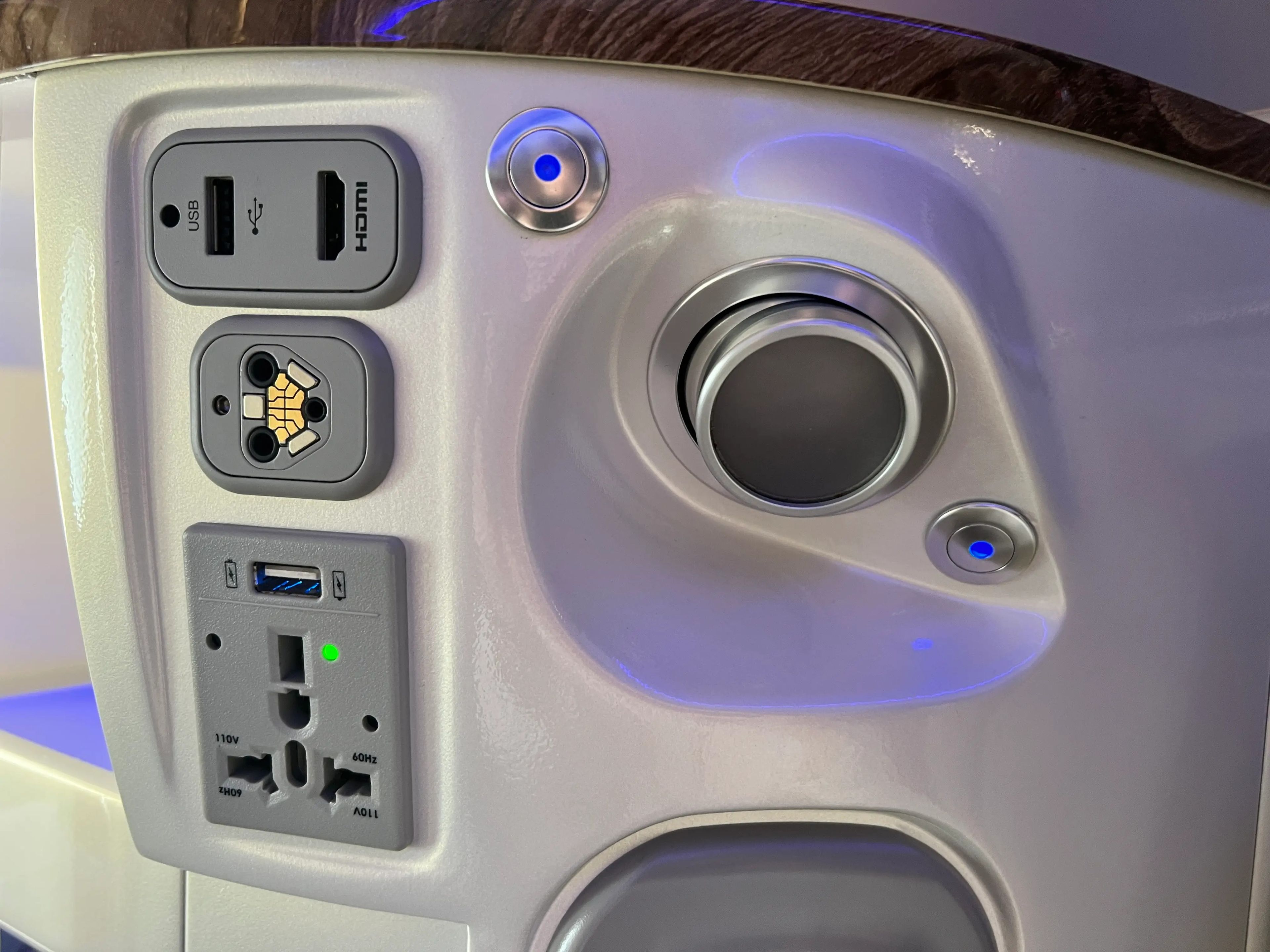 Plug and USB sockets and an air condition unit are seen on the console of a business class seat on Emirates A380