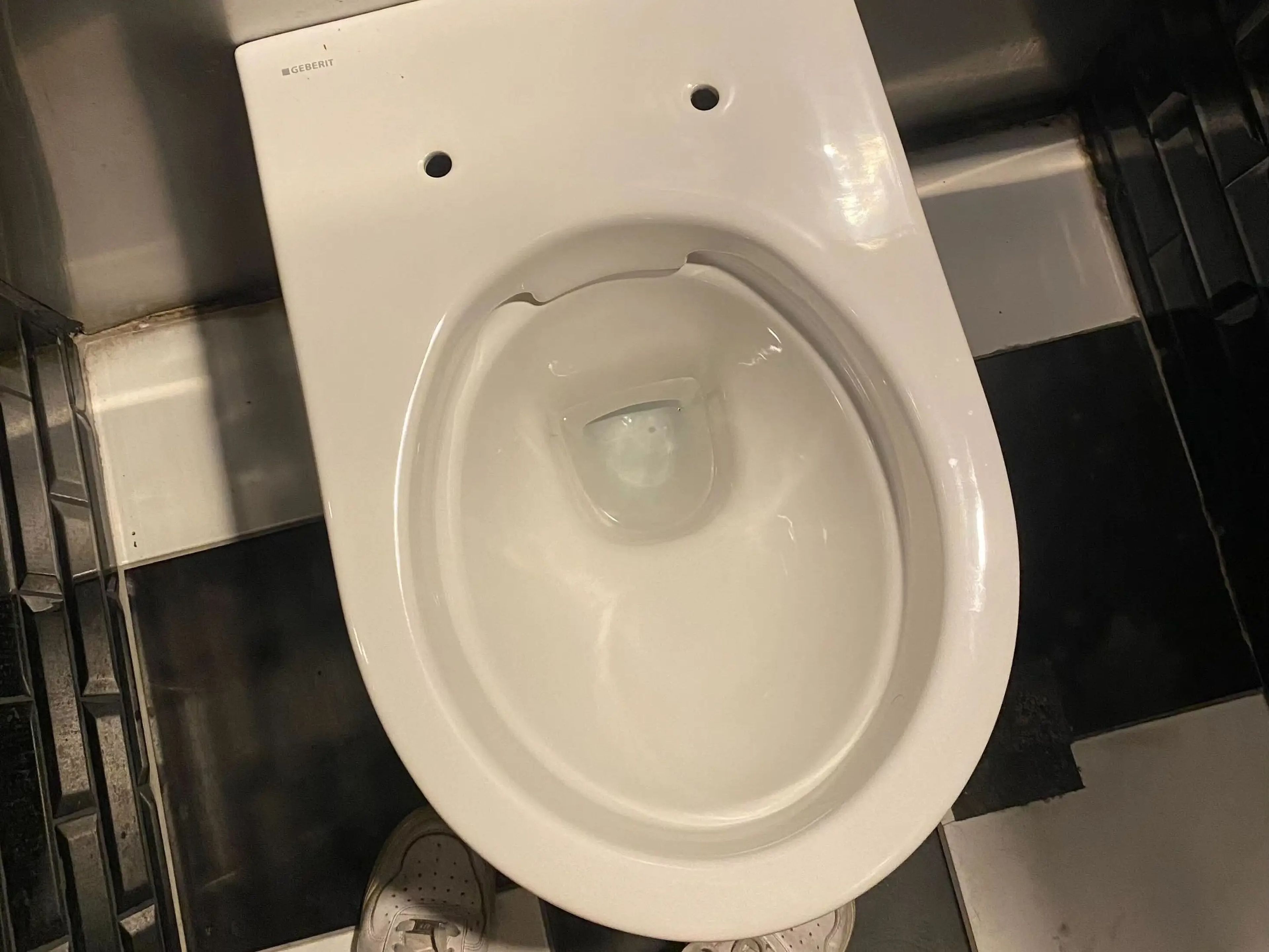 A toilet without a seat.