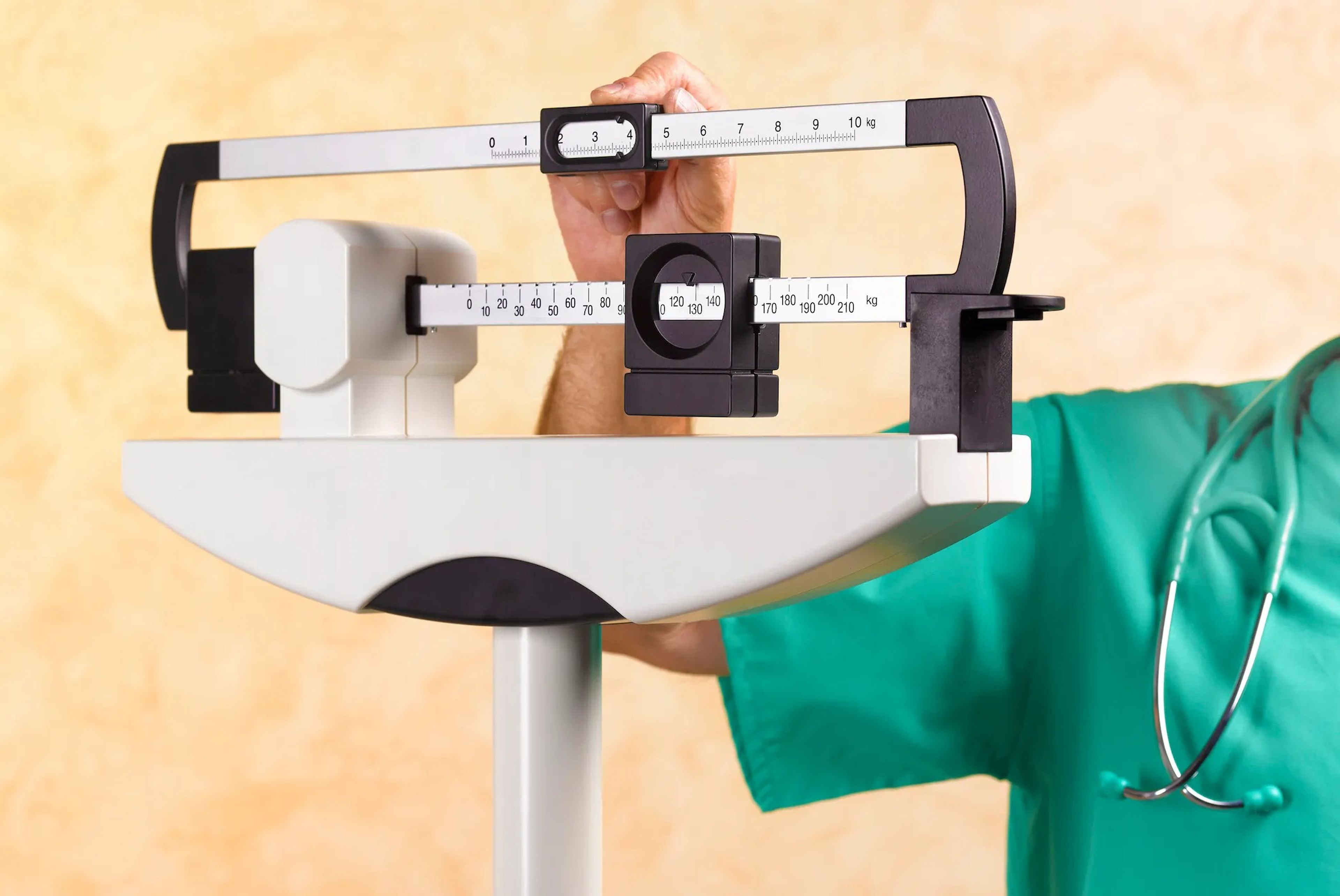 doctor moving weights on scale