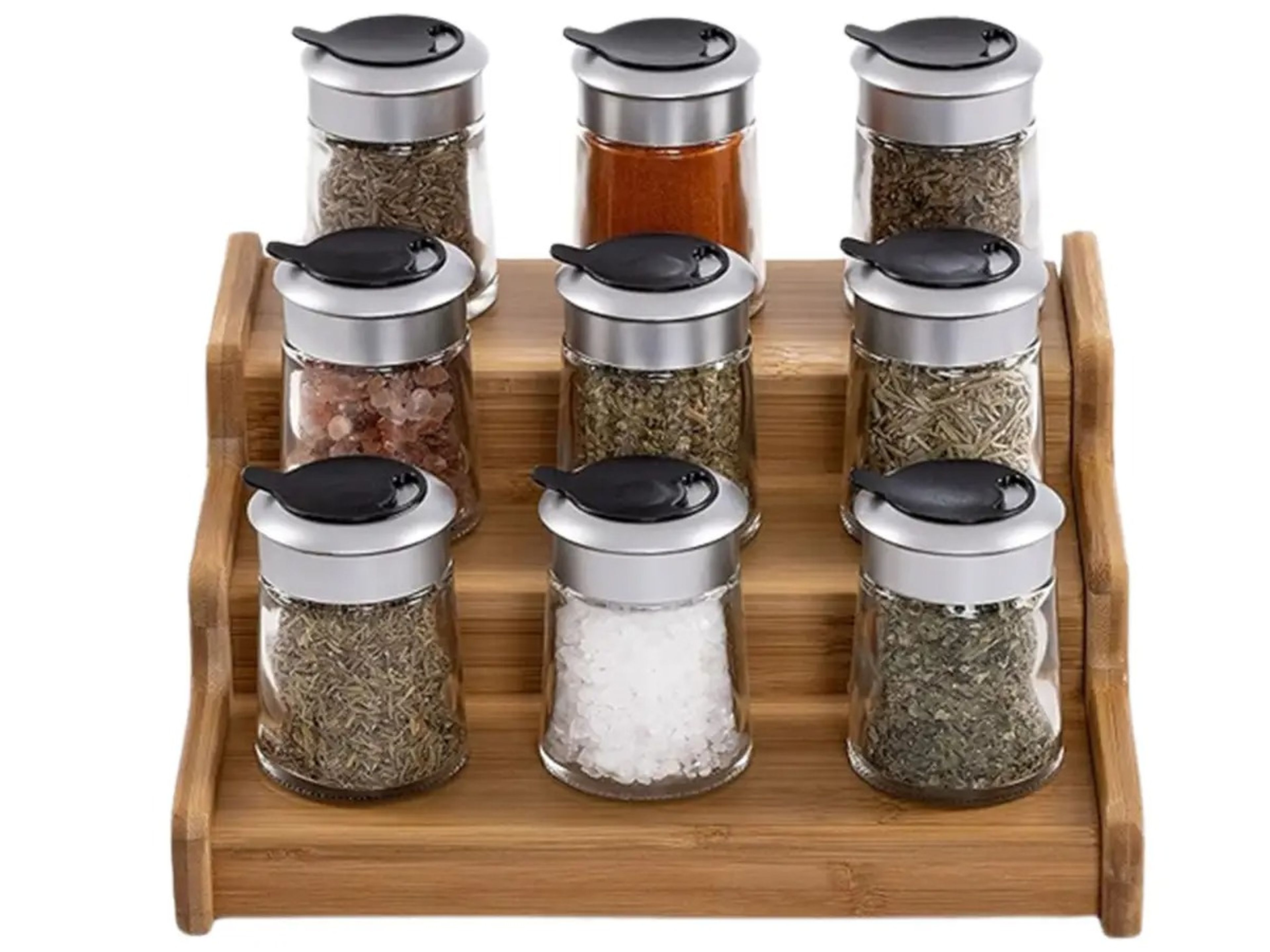 A small wooden spice rack with 9 different spices in small spice jars.