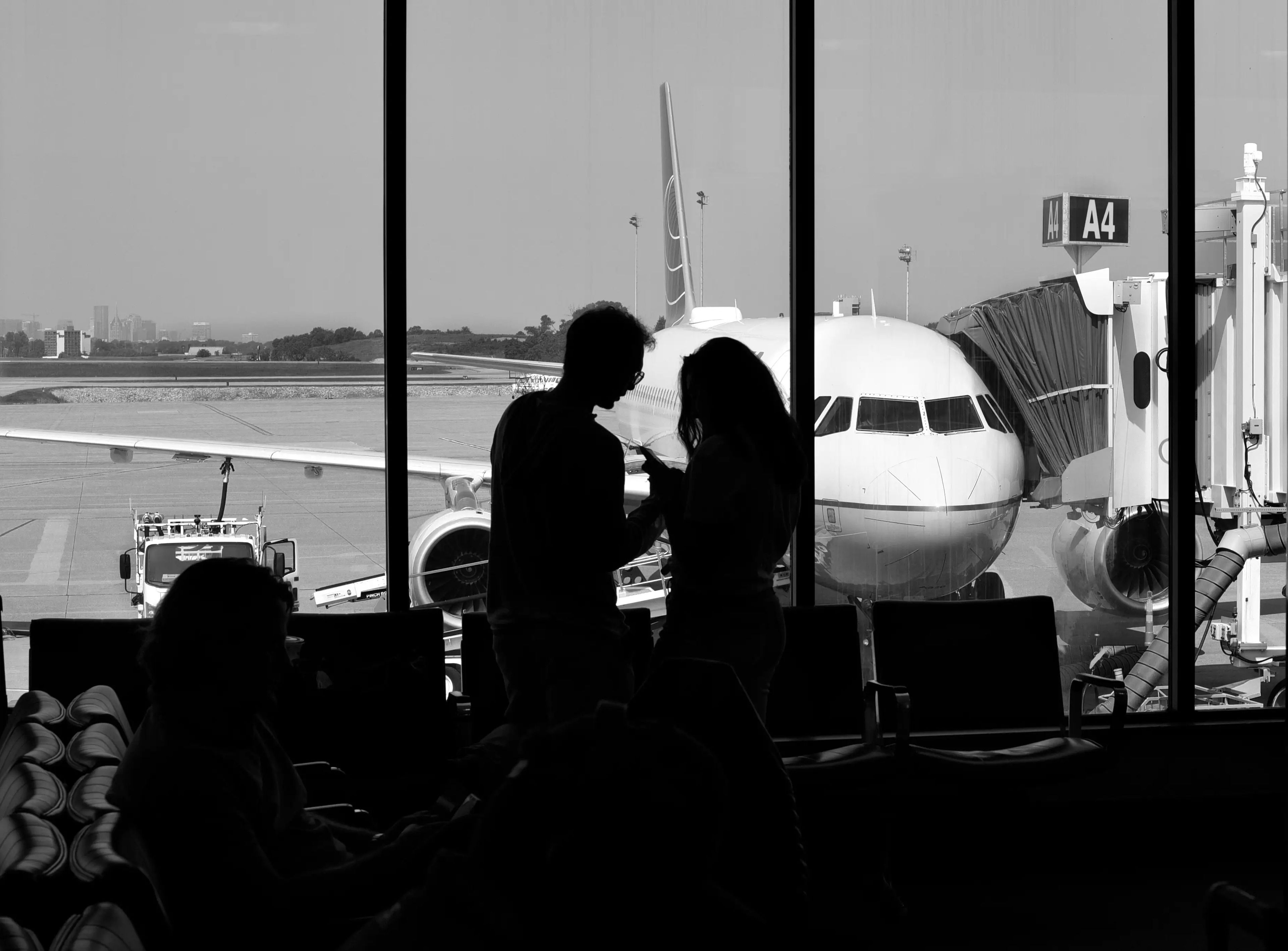 Two people standing in a boarding area.