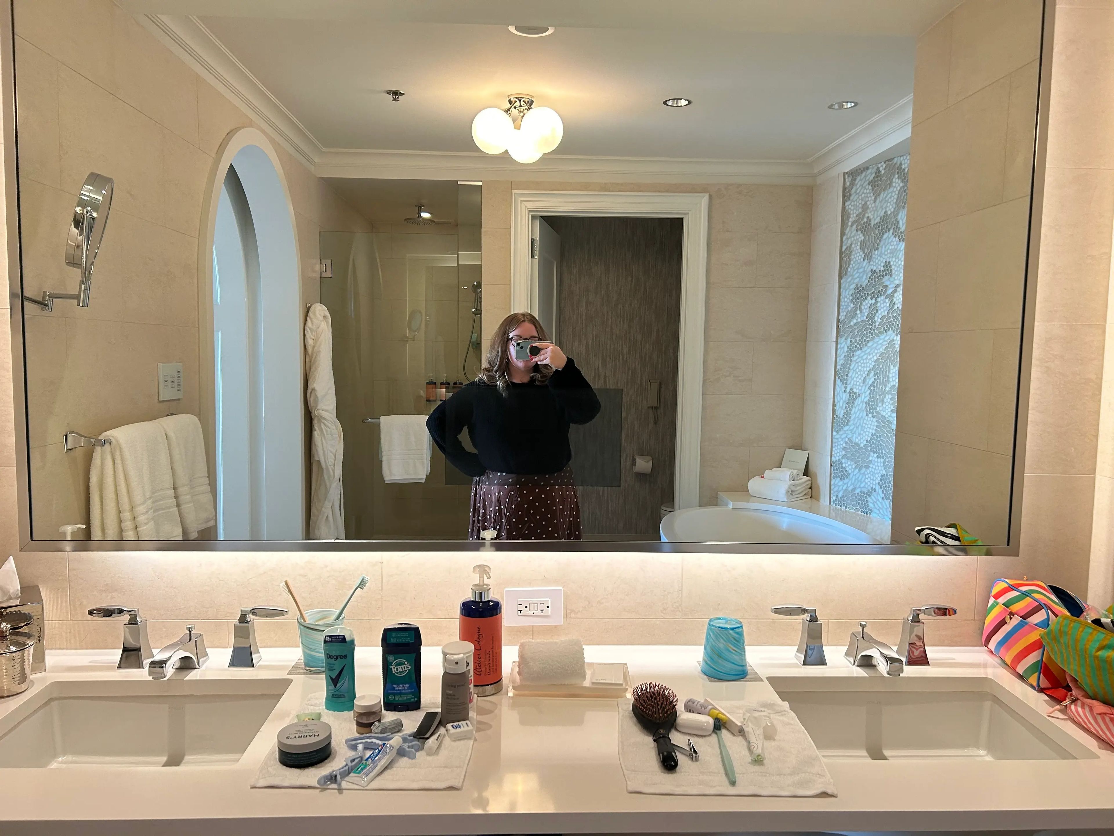 Author Jacqueline Dole taking selfie in mirror of bathroom at Disney World Four Seasons suite