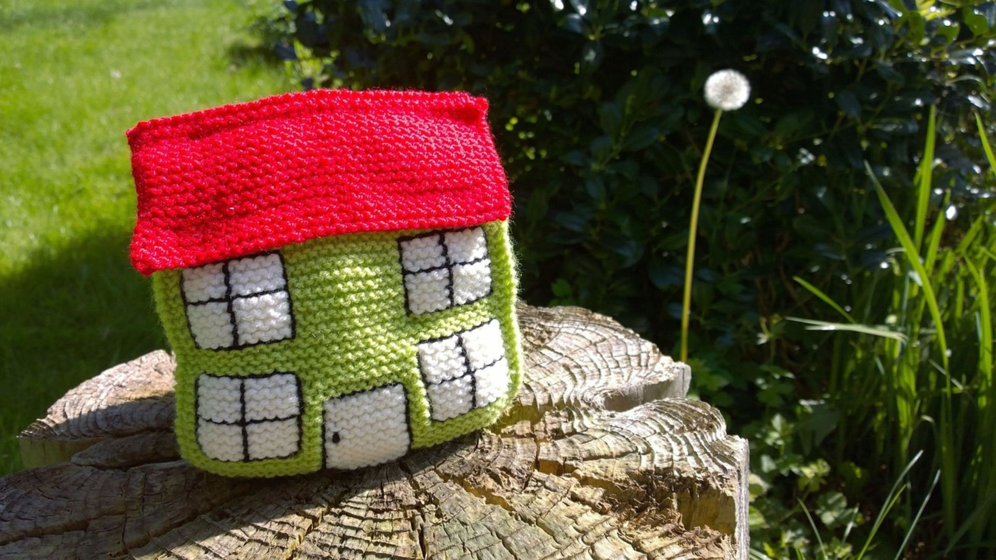 Un bolso hecho de lana y con forma de casa.
