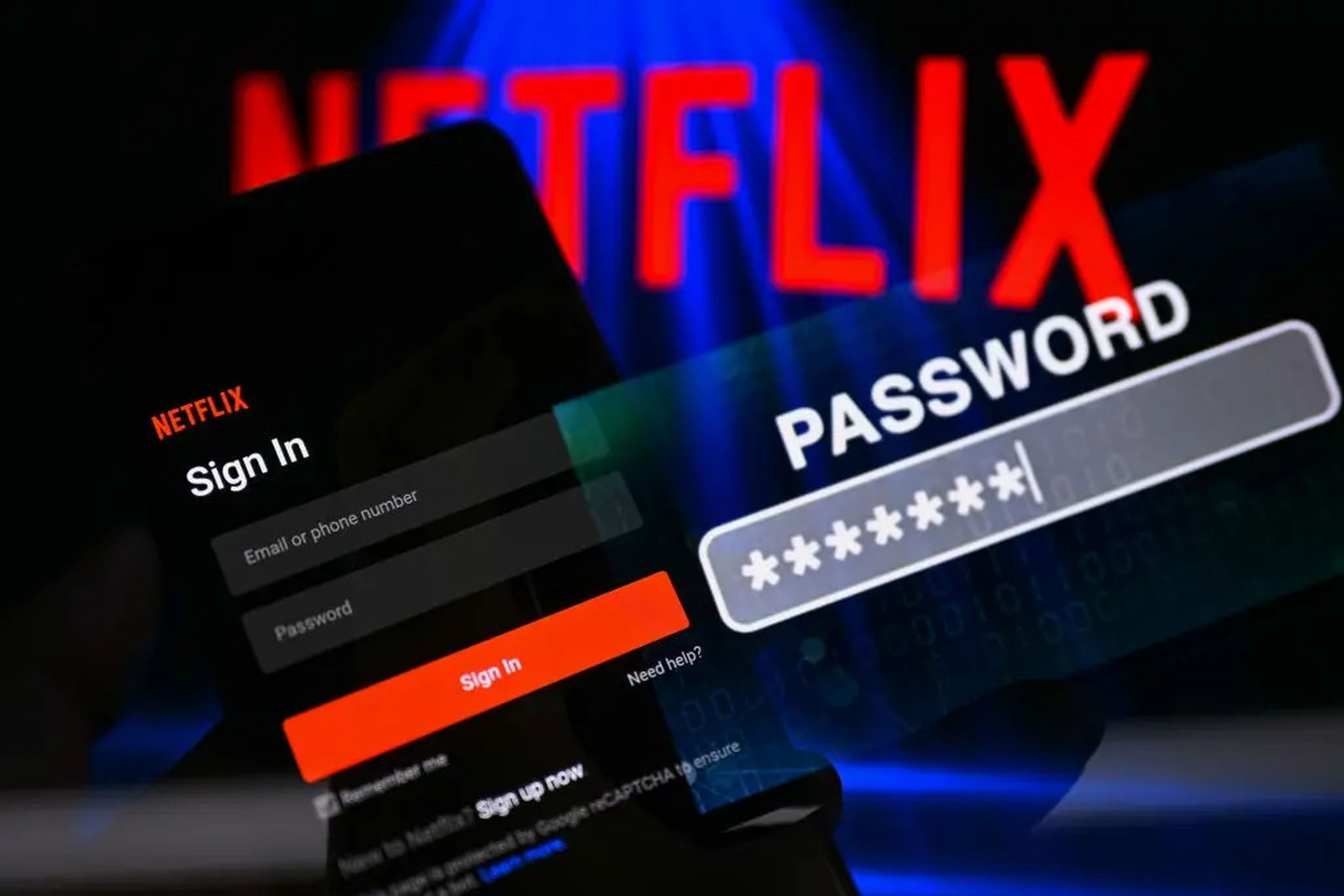 A close up of a phone displaying the sign-in page to Netflix, with the company logo in the background.