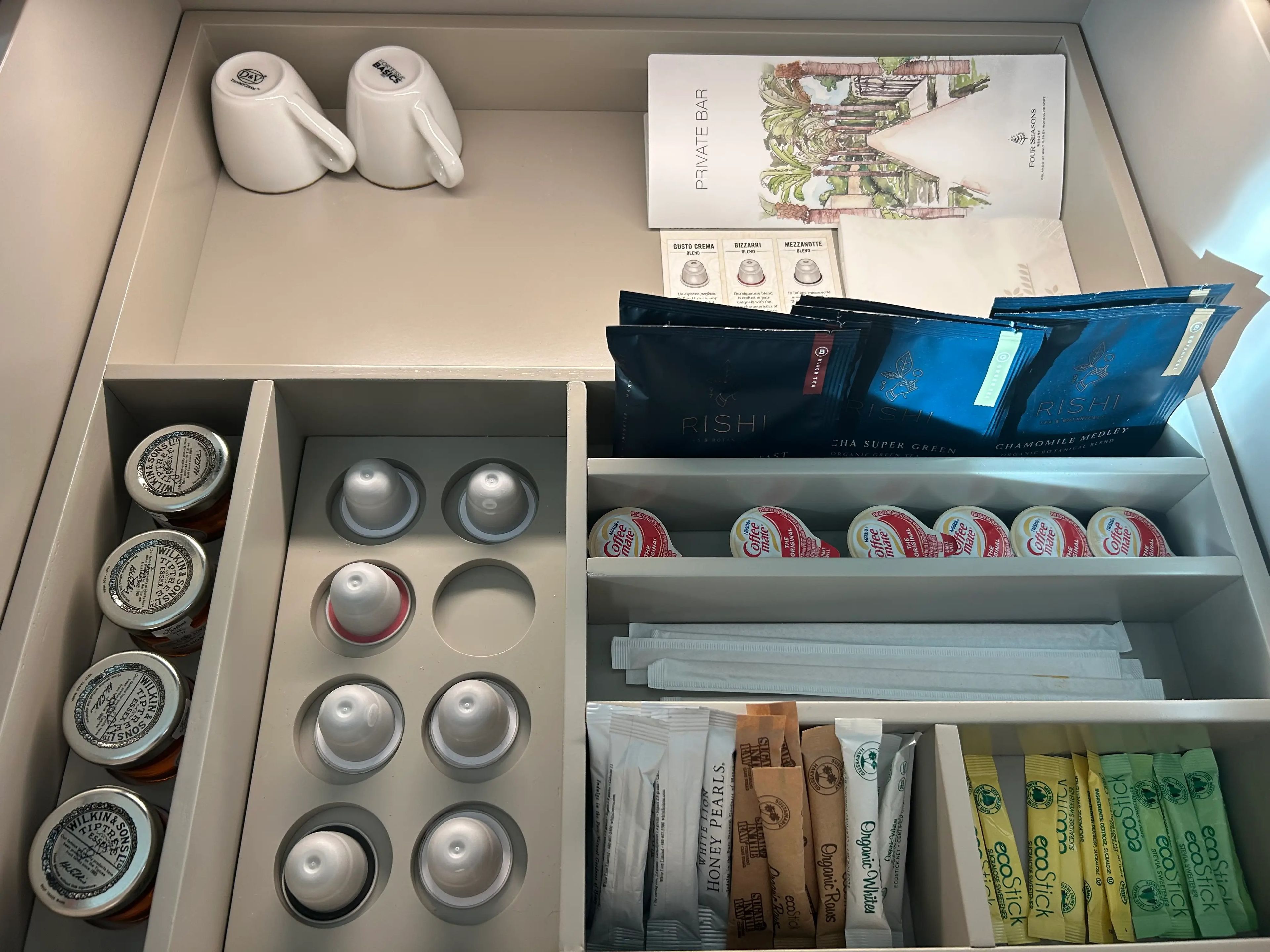 Drawer inside room with coffee pods and sugar 