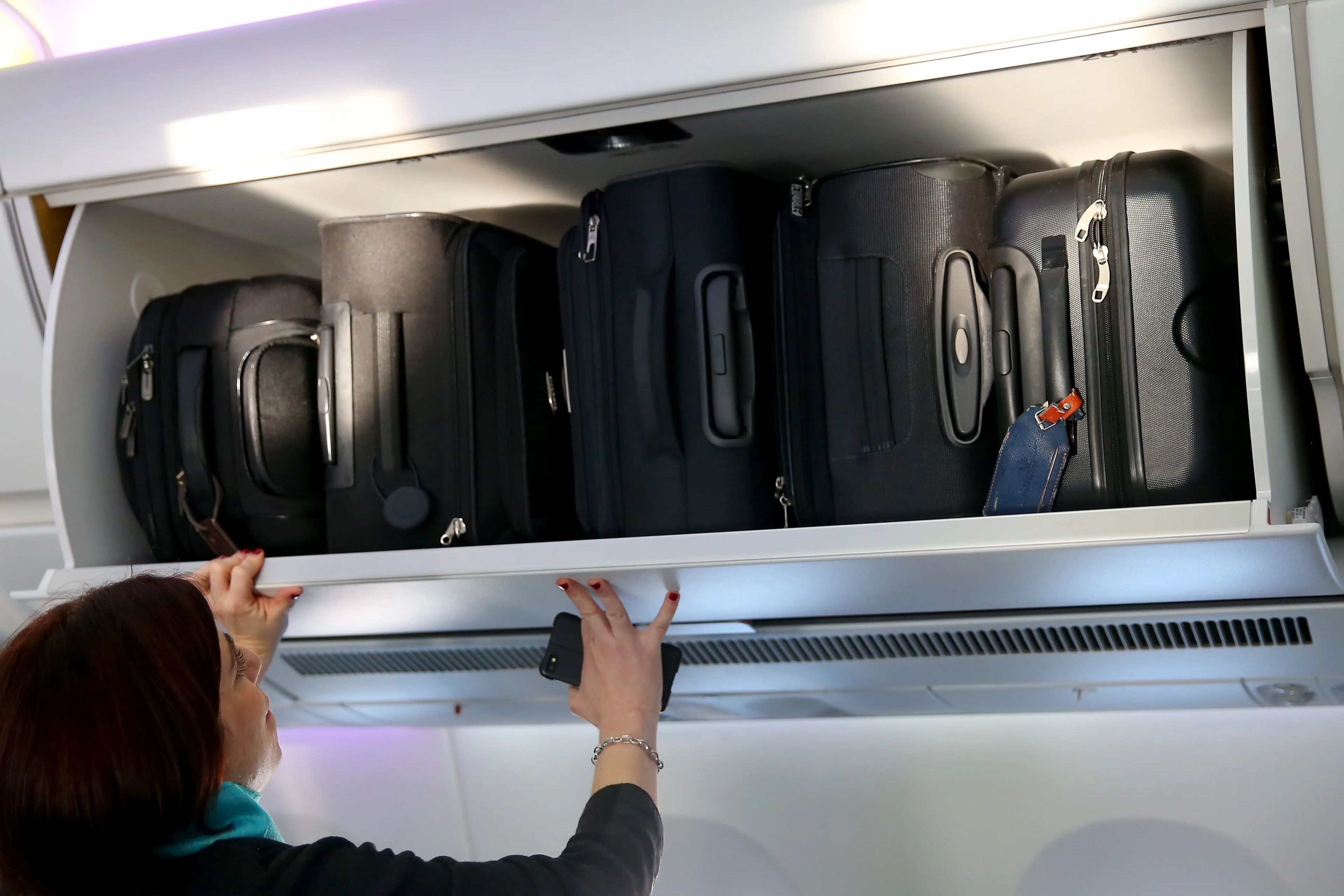 The hand baggage overhead bins in the cabin of a passenger plane