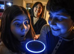 Laura Labovich, background, and her children Asher, right, 13, and Emerson, left, 10, with the family "Alexa", an artificial intelligence device, on January, 29, 2017 in Bethesda, MD.