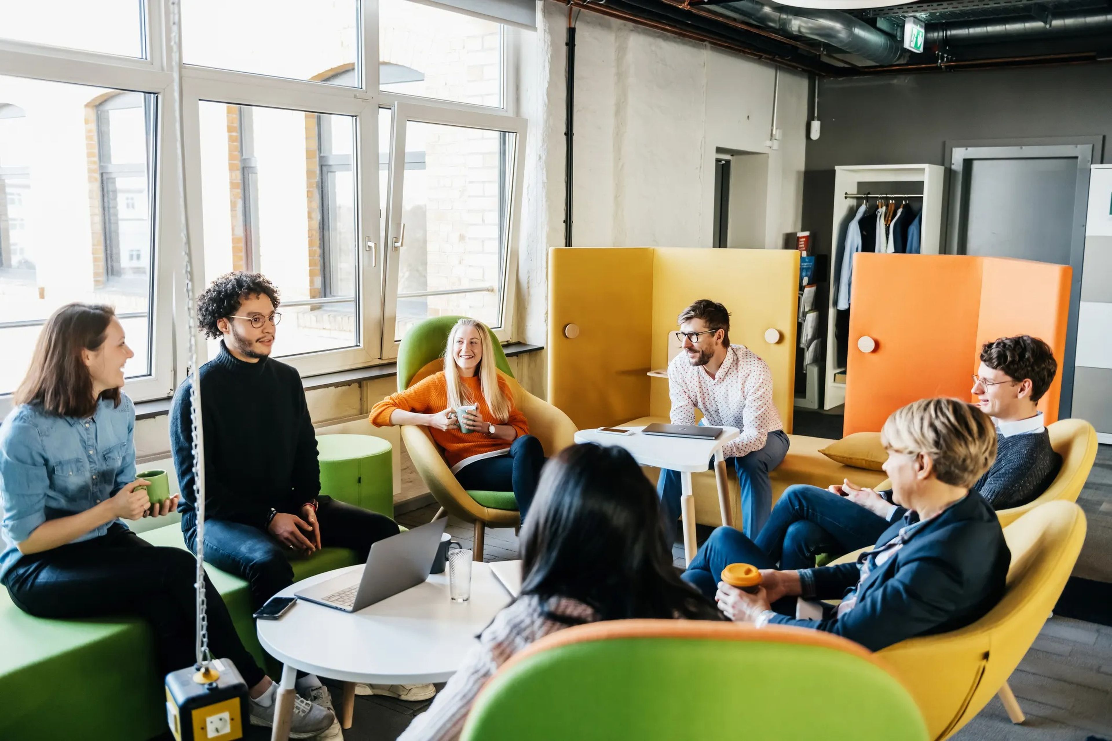 Millennial workers sitting in colorful office