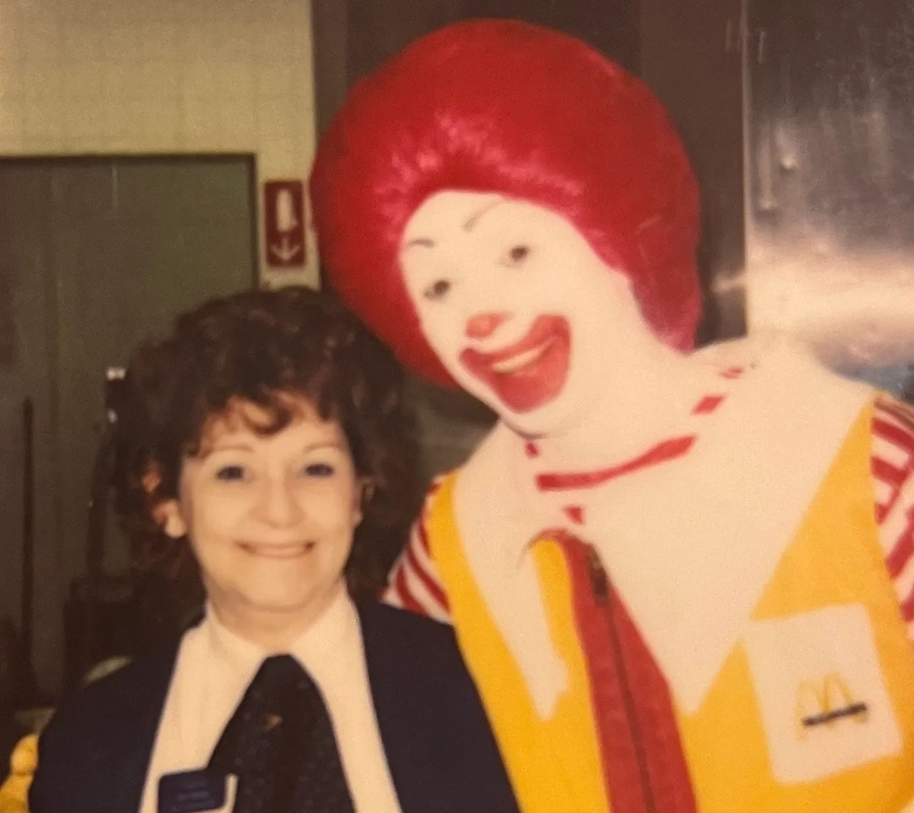 An old photo showing Dot Sharp, a McDonald's worker, and a man dressed as Ronald McDonald