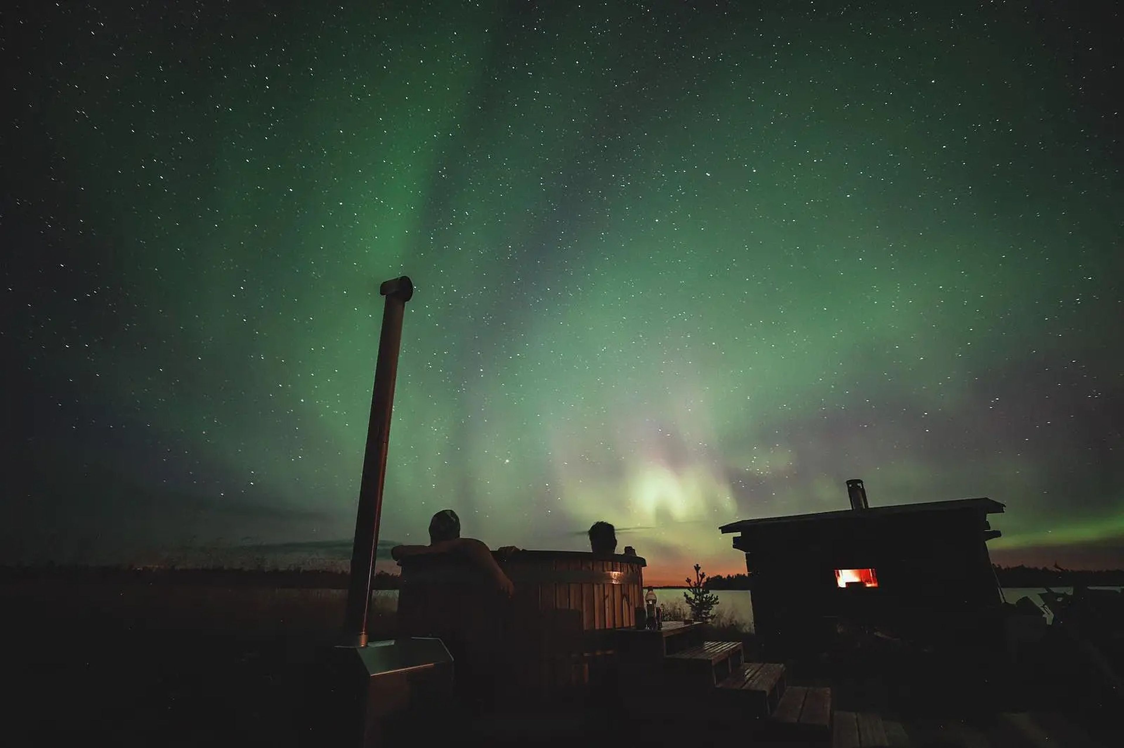 Petri Kokkonen's cabin in the Finnish wilderness during the Northern lights.