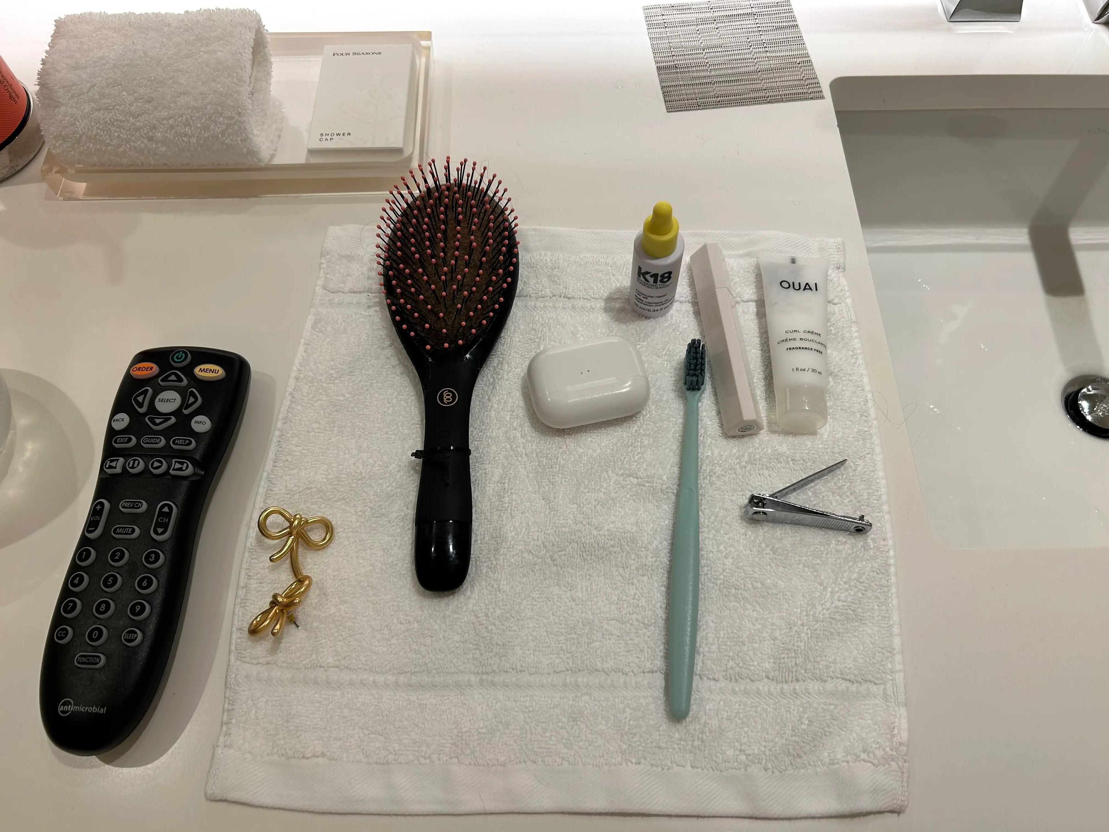 Toiletries and brush laid on wash cloth on counter in Disney World Four Seasons room