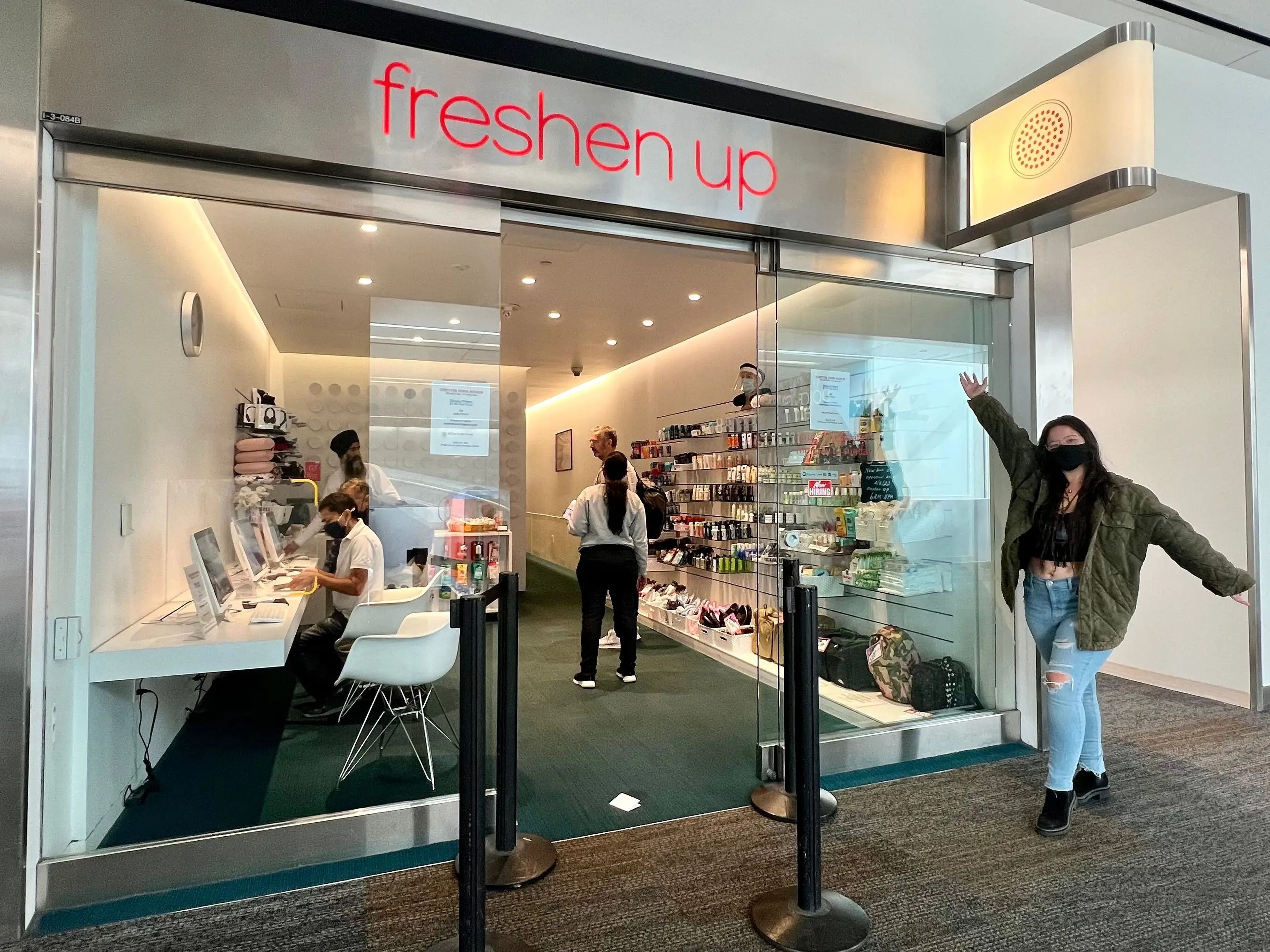ashley posing in front of freshen up at san francisco international airport
