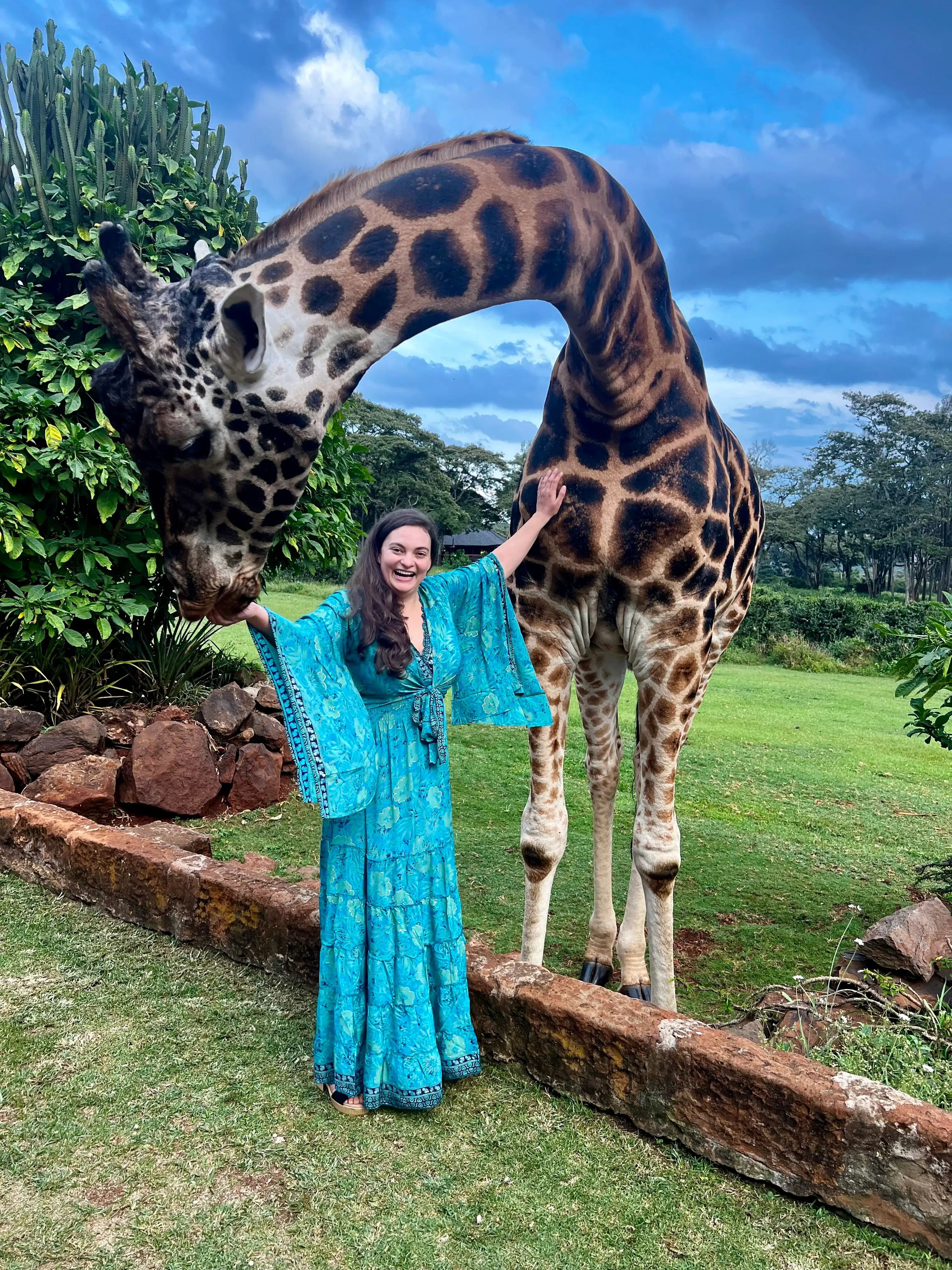 Author Jen Ruiz petting a giraffe