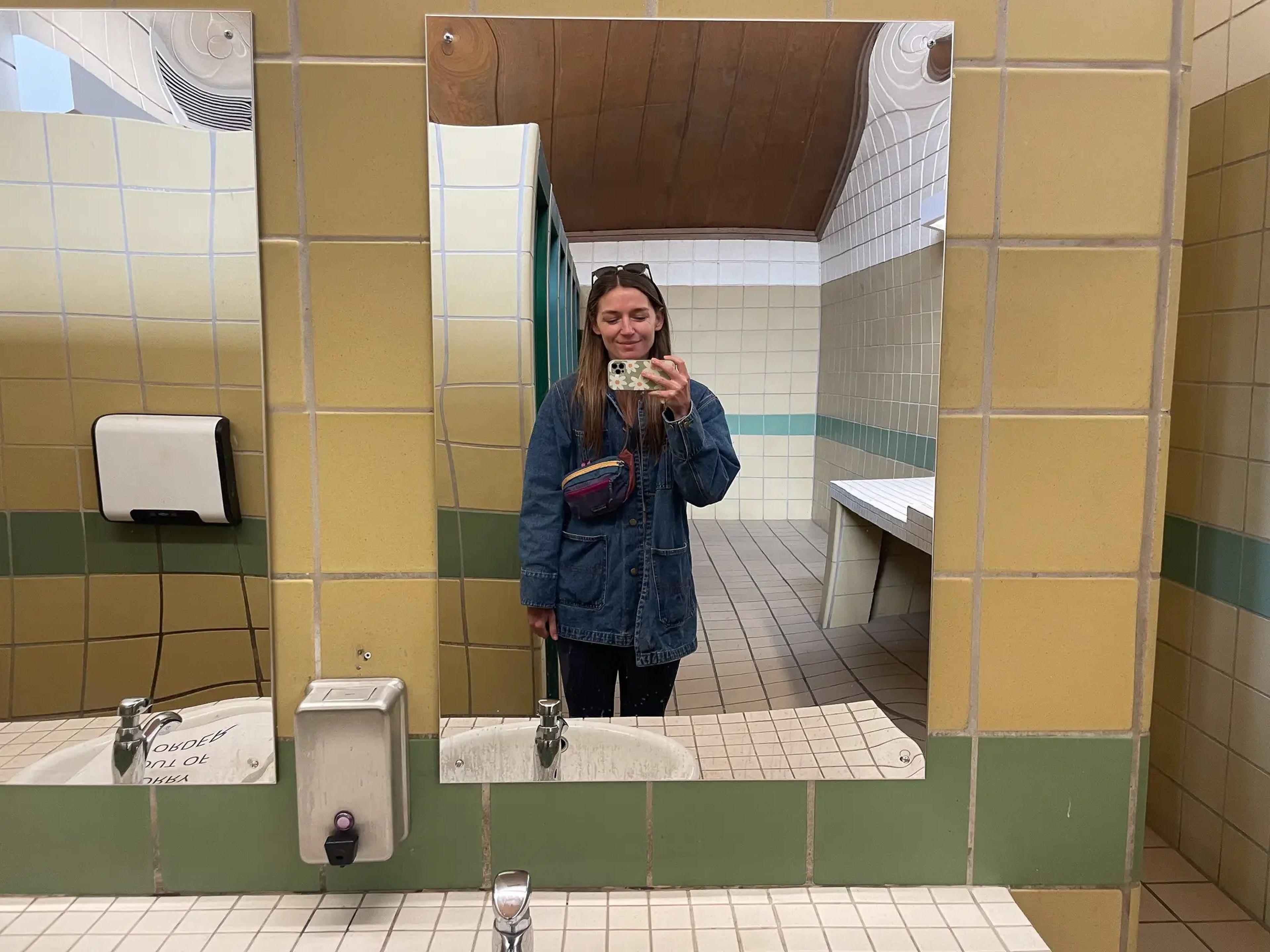 The author in a rest stop bathroom during her two-week road trip in a campervan.