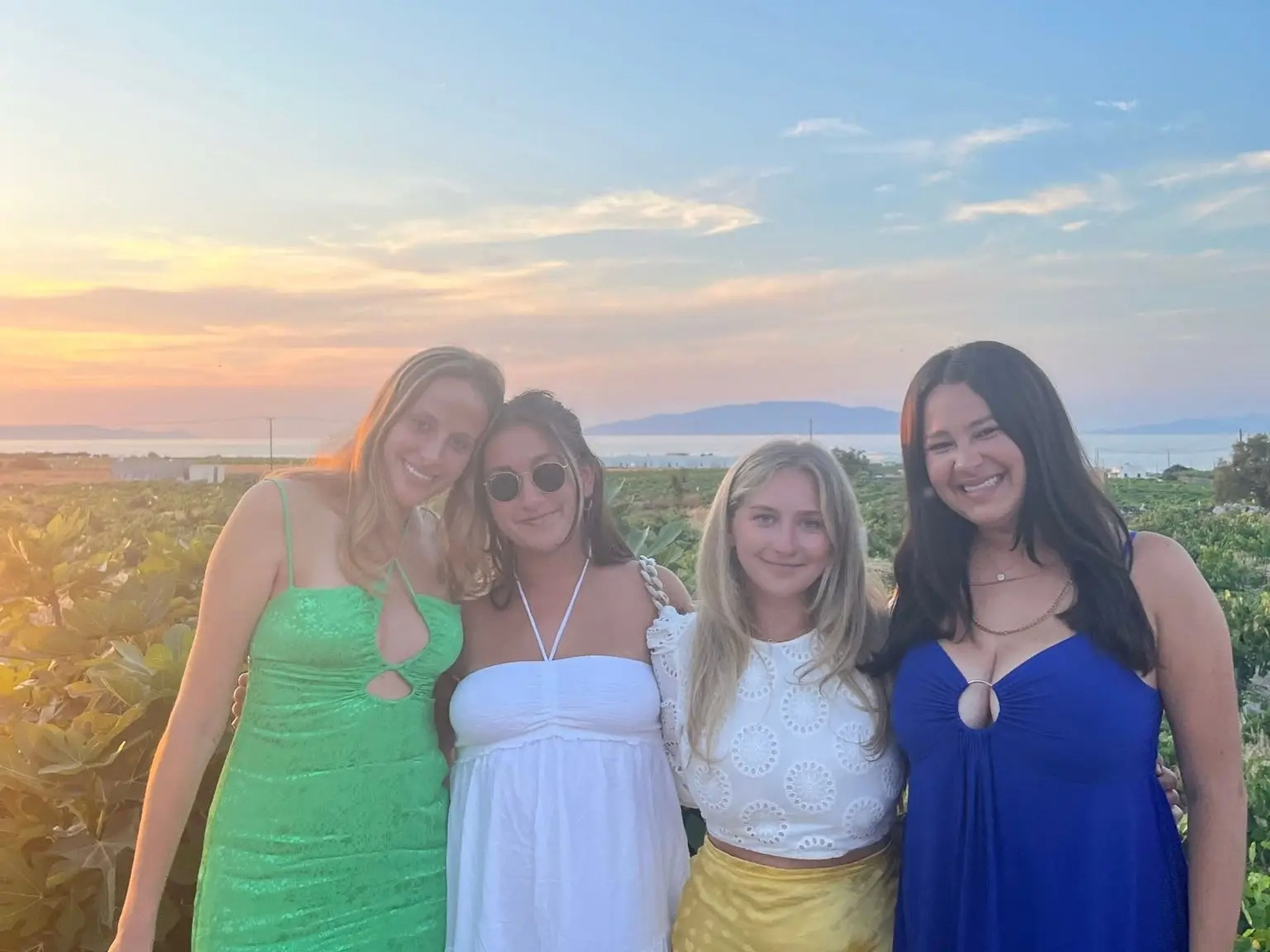 jordana and her friends posing in a vineyard in greece at sunset