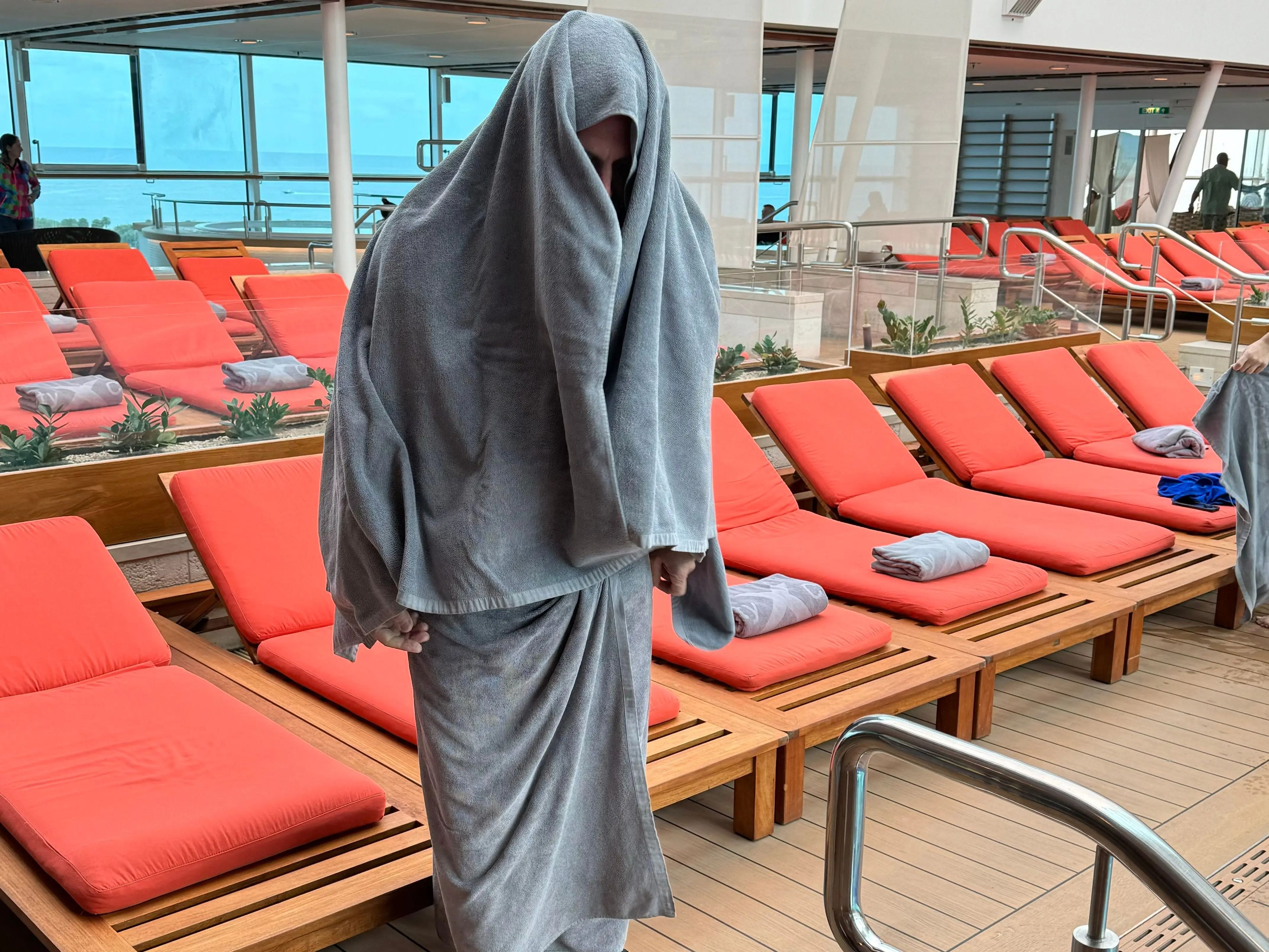 jordana's dad covered in towels on a cruise ship deck