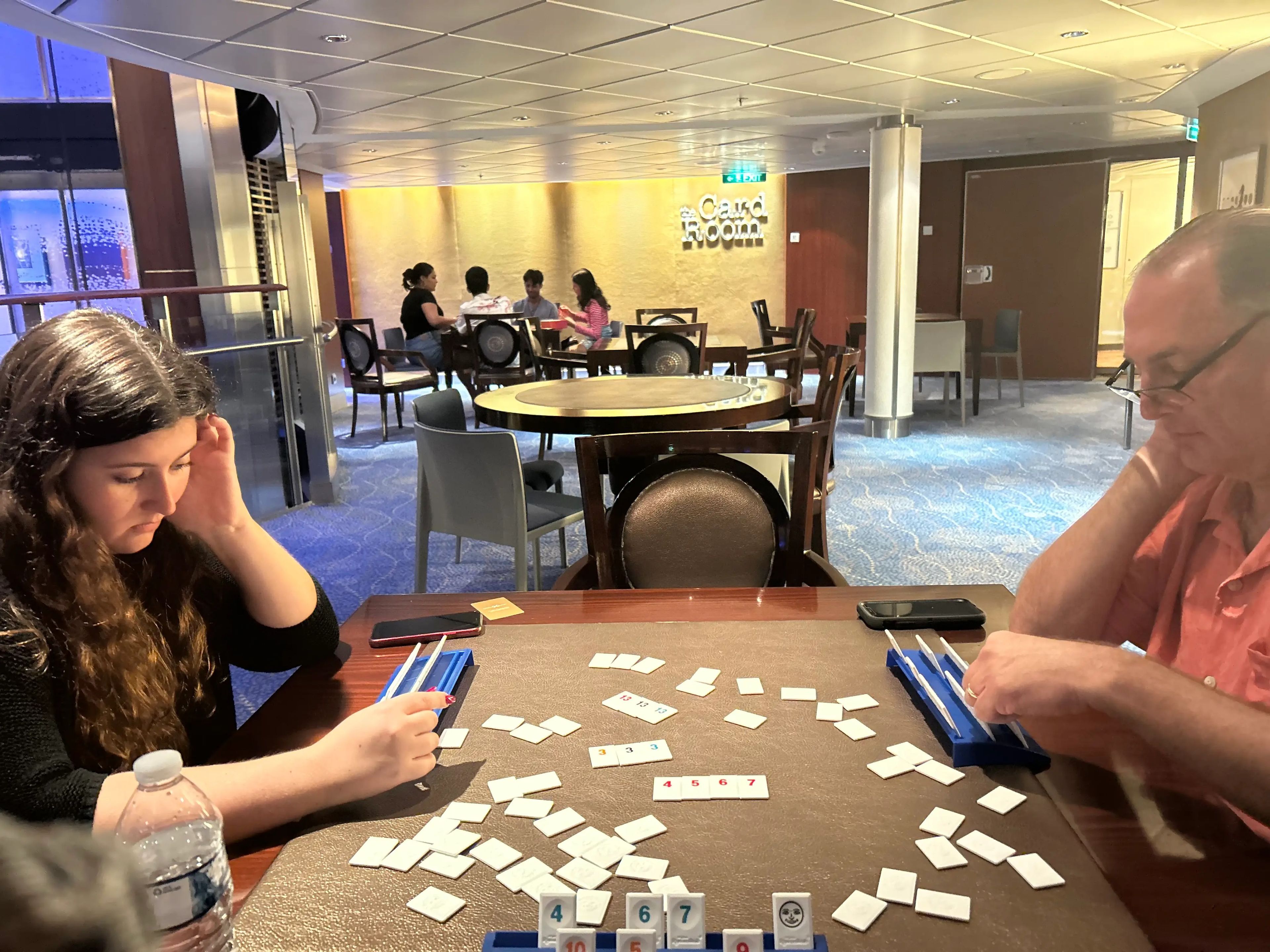 jordana's family playing games in the card room of a cruise ship
