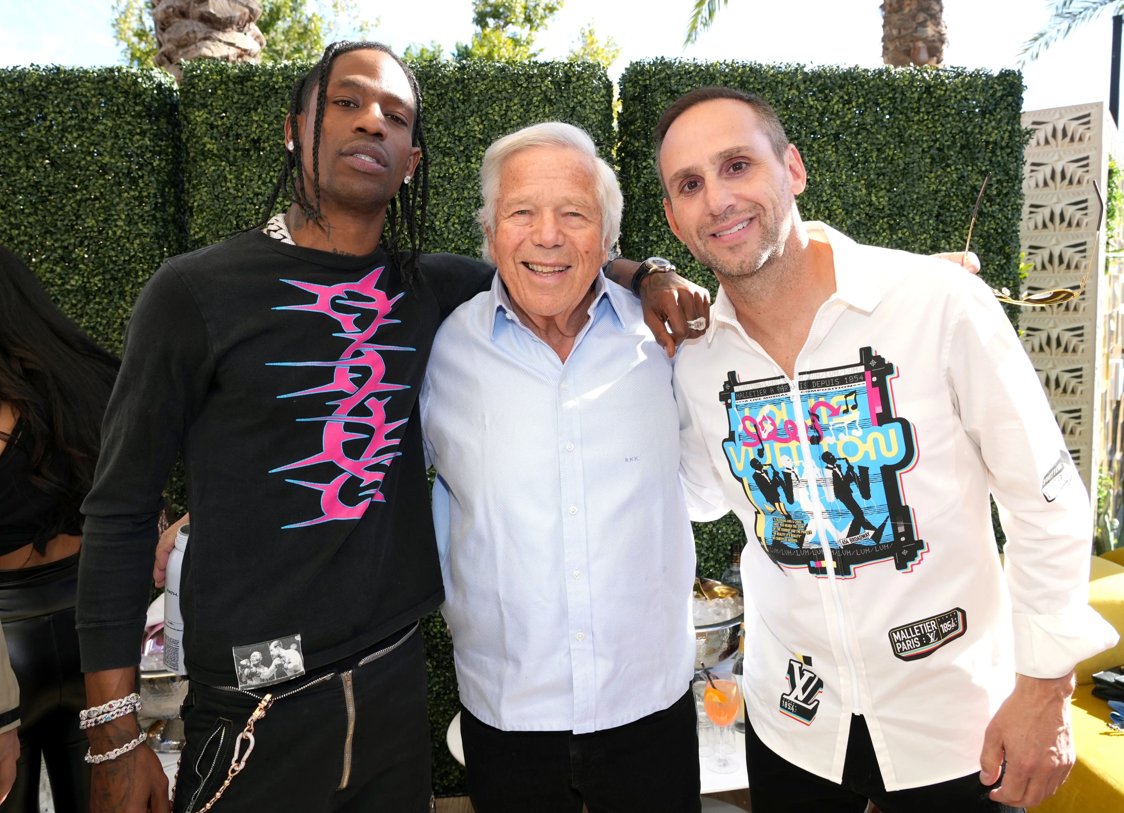 Los multimillonarios Robert Kraft (centro), propietario de los New England Patriots y del grupo Kraft, y Michael Rubin (derecha), CEO de Fanatics, con el rapero Travis Scott (izquierda) en una fiesta del año pasado.