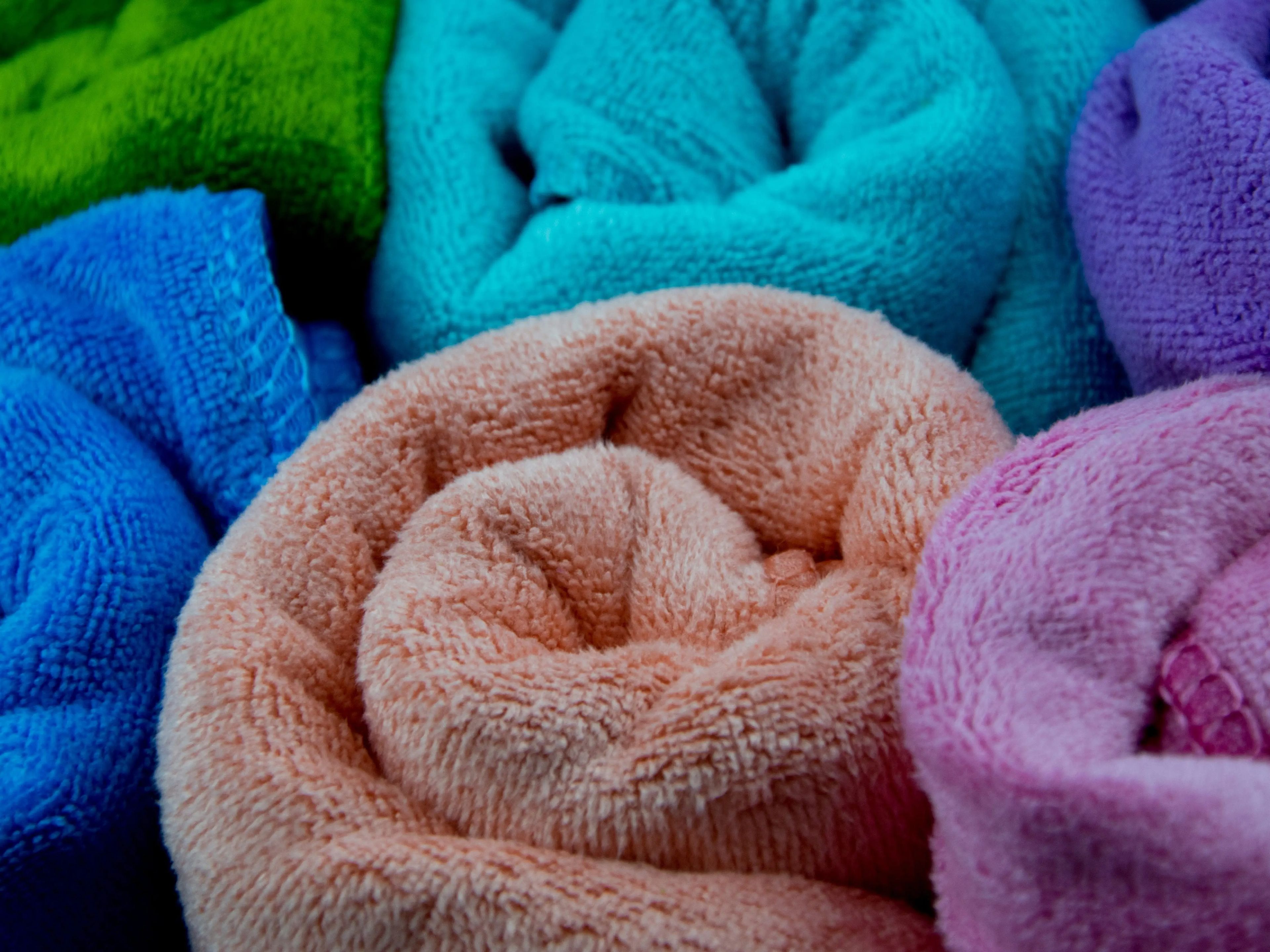 rolls of microfiber towels rolled up — closeup shot of multicolor towels