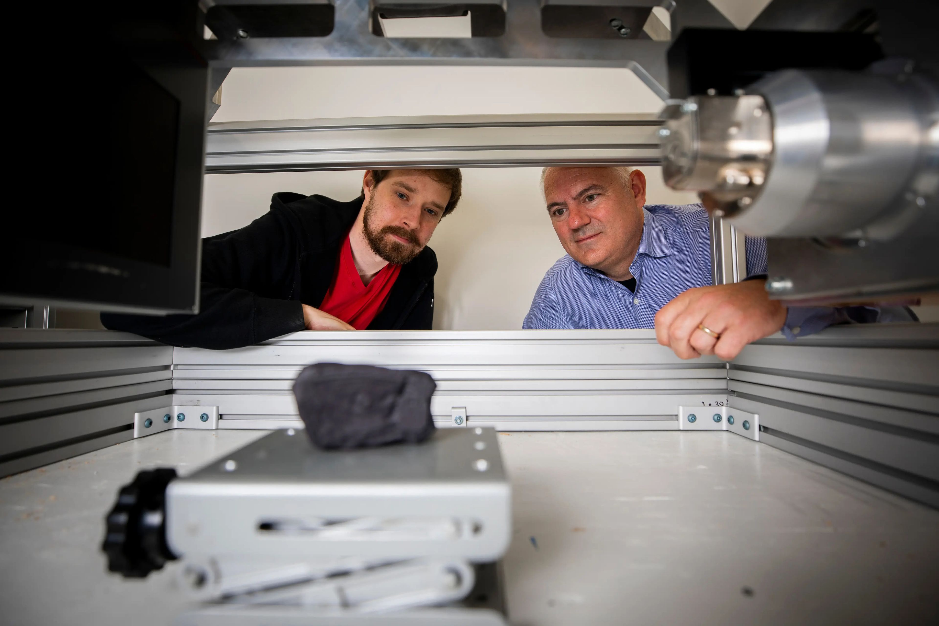 Seth Parker and Brent Seales scan a replica of the Herculaneum scroll in a machine