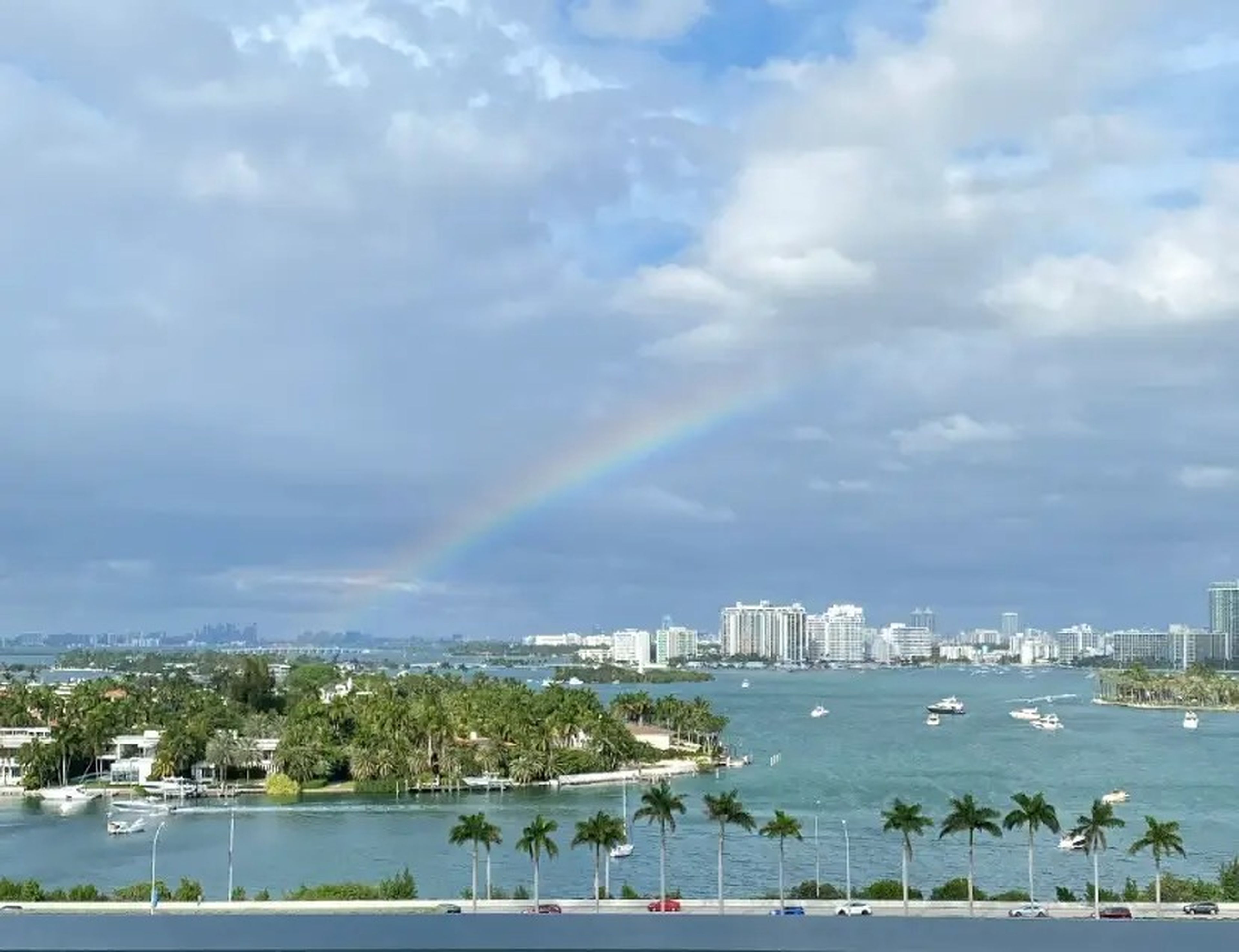 shot of a rainbow stretching over a cruise port in Florida on a cloudy day