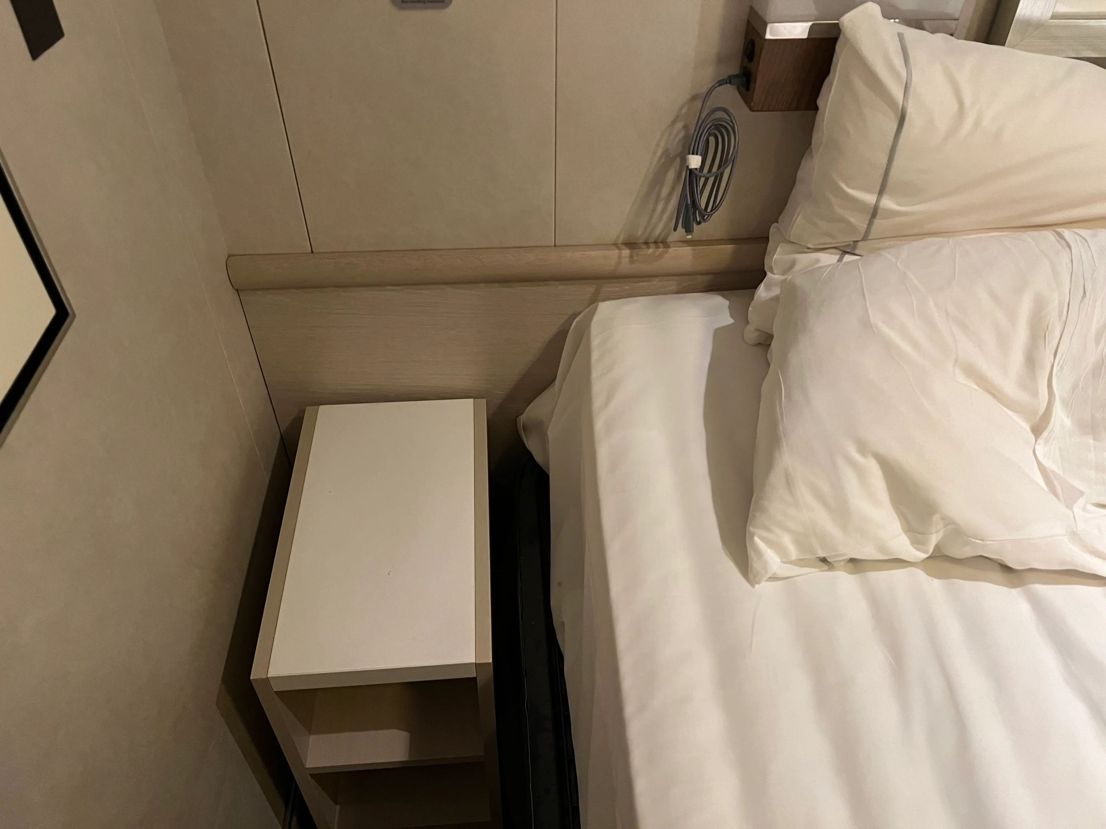 The side table and USB charger next to the bed.