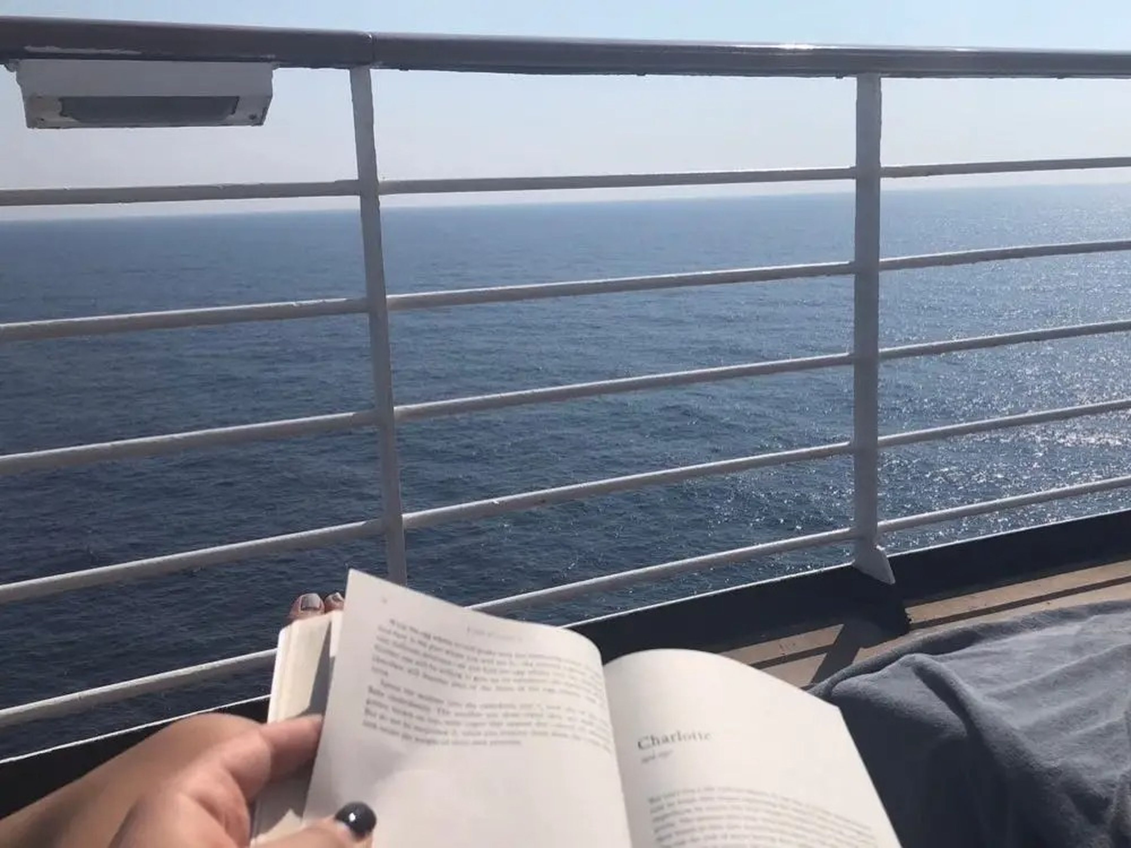 someone reading on a cruise ship deck