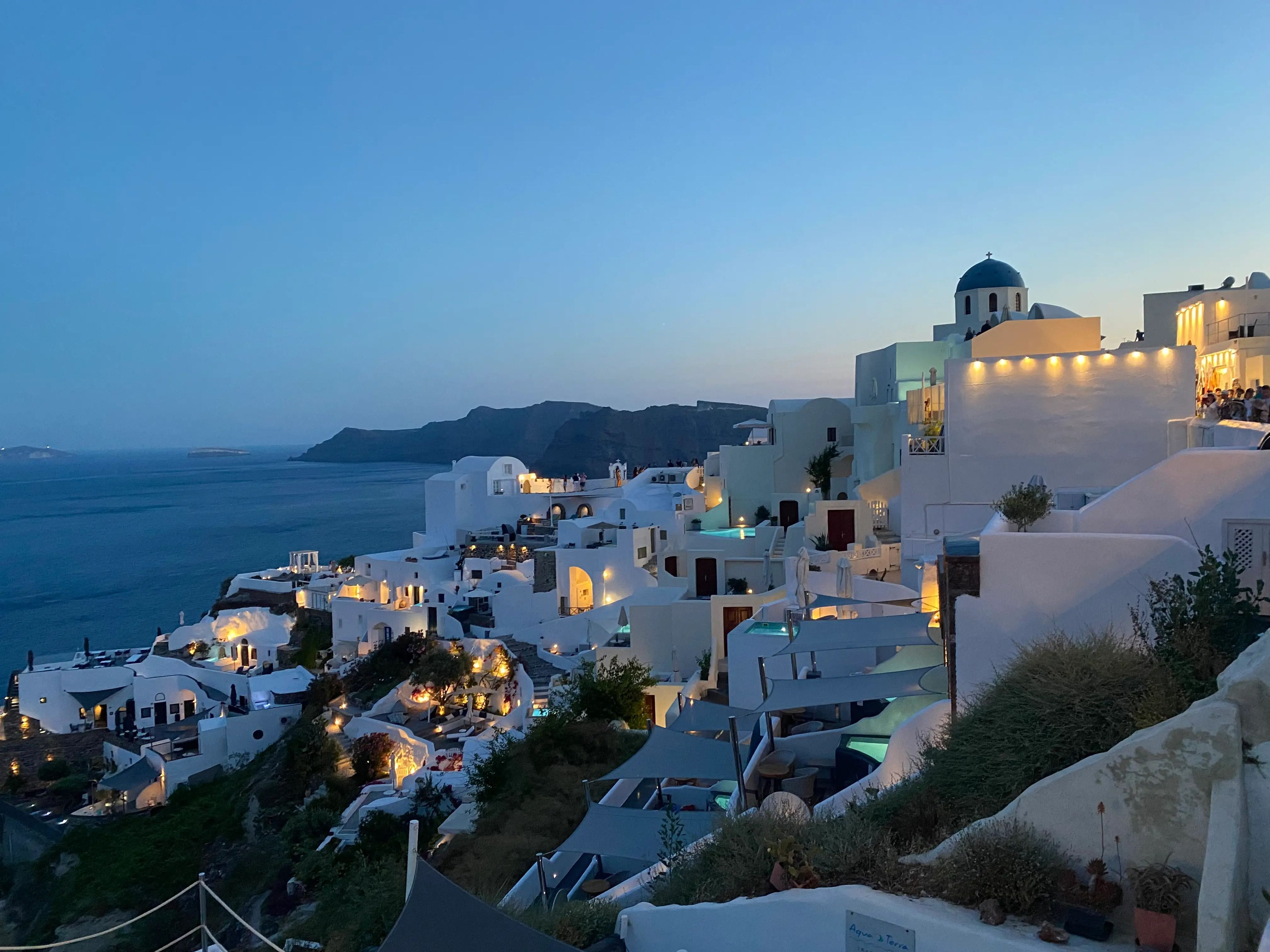 view of santorini in greece lit up at night