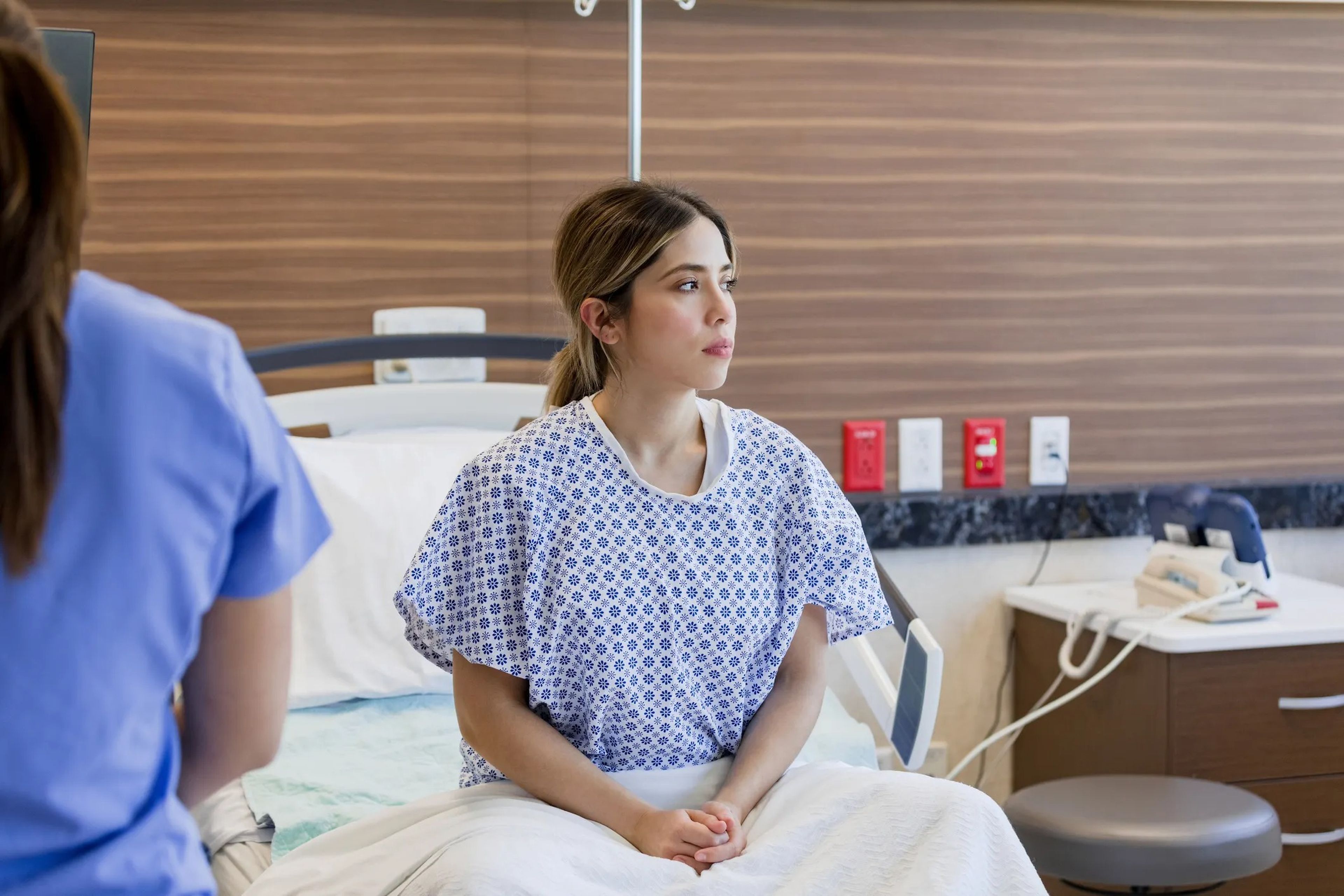 Young woman in a hospital bed.