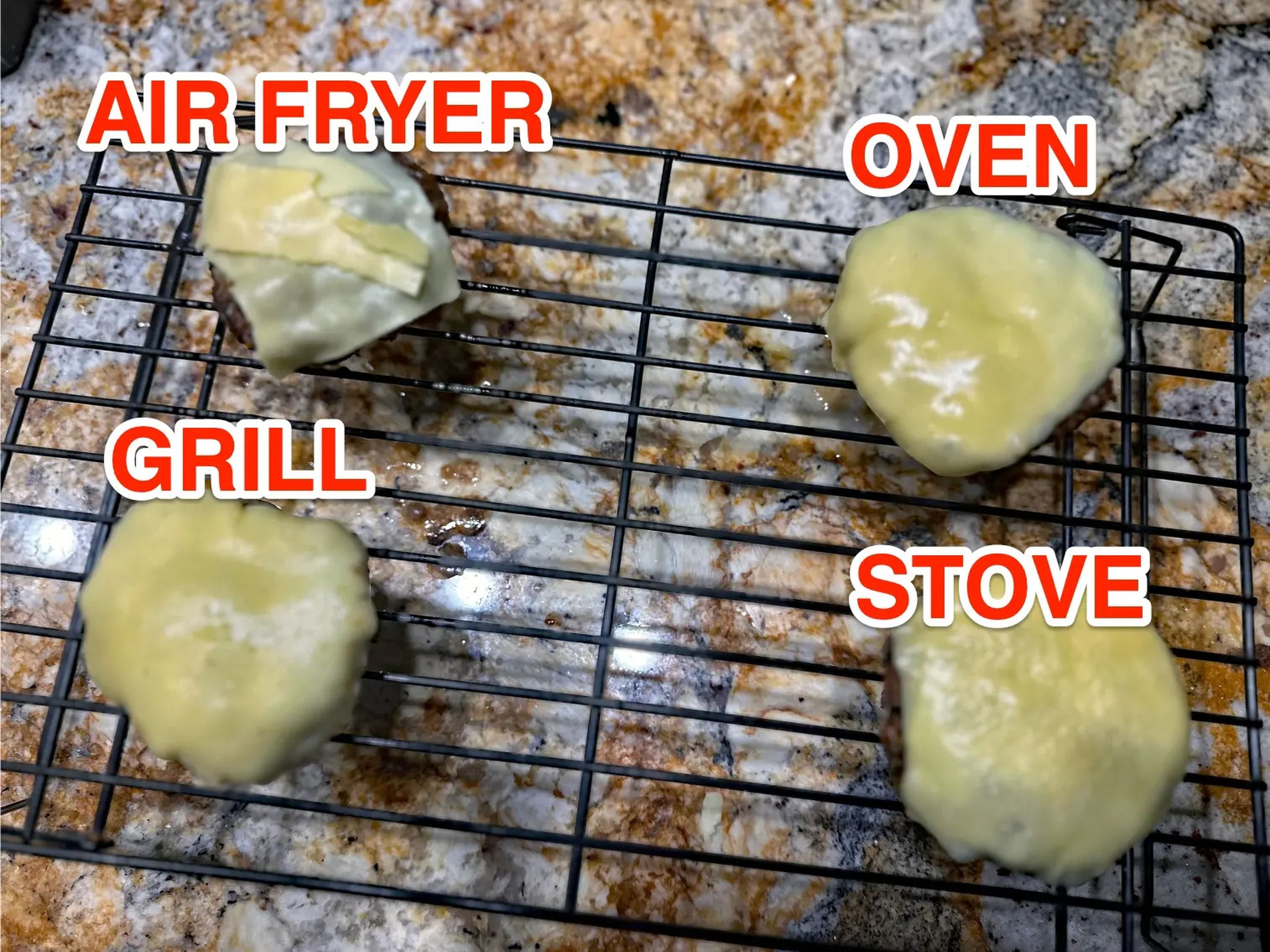 cheeseburgers made in the air fryer, oven, grill, and stove labeled on a cooling rack