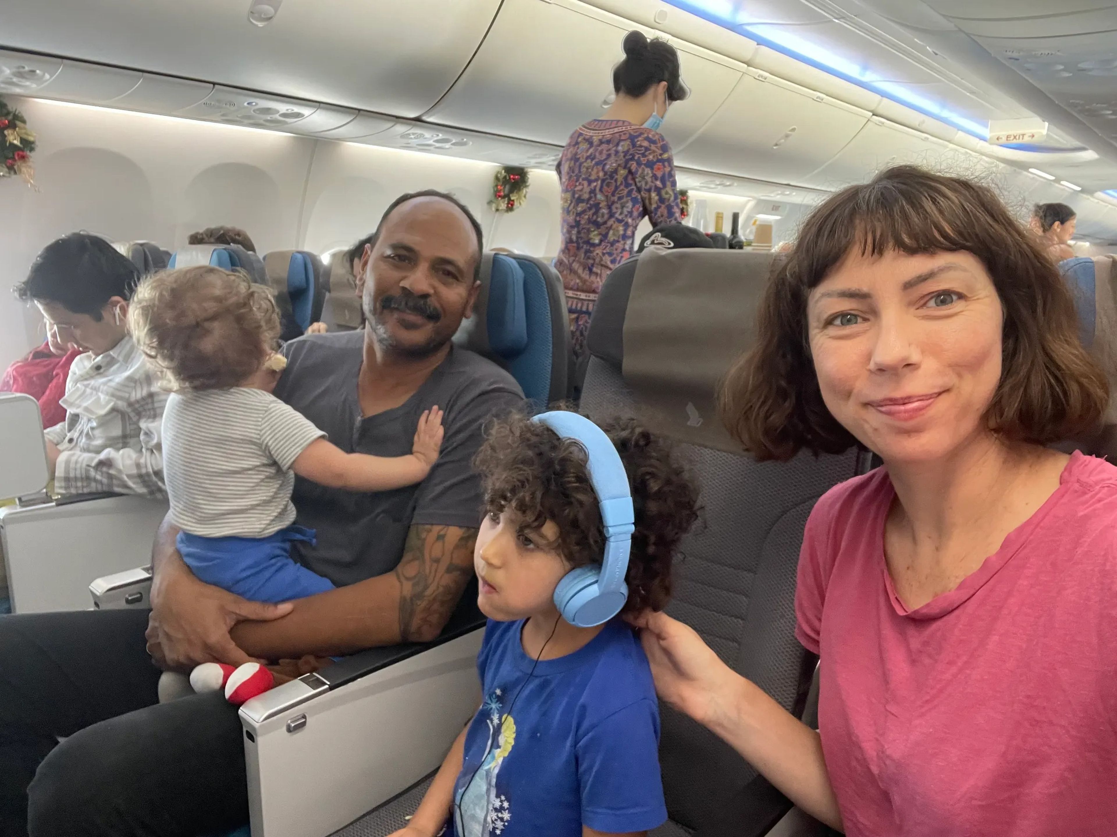 Family posing for photo on plane