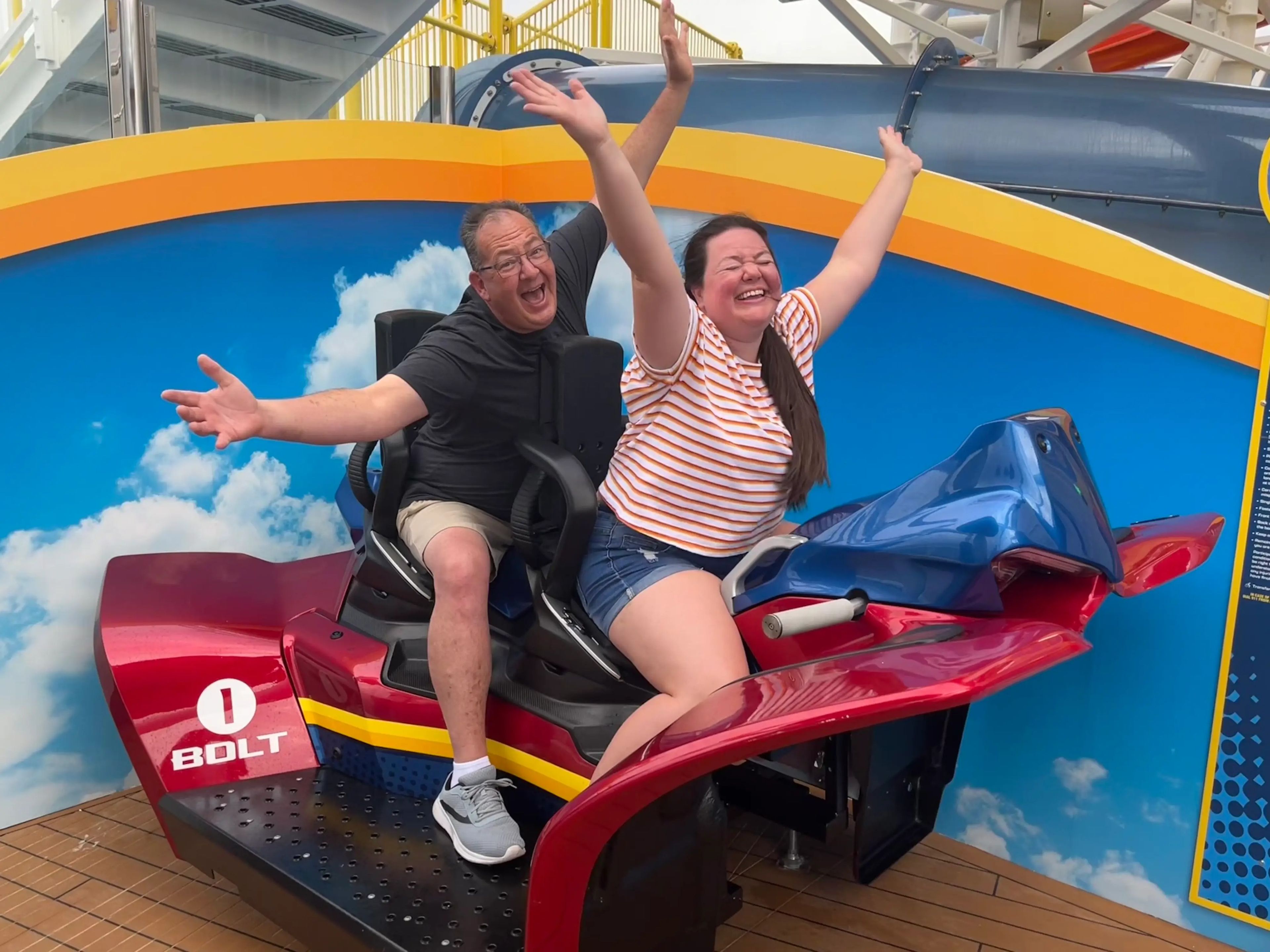 megan and her dad in the test seat for the bolt roller coaster on a carnival cruise ship