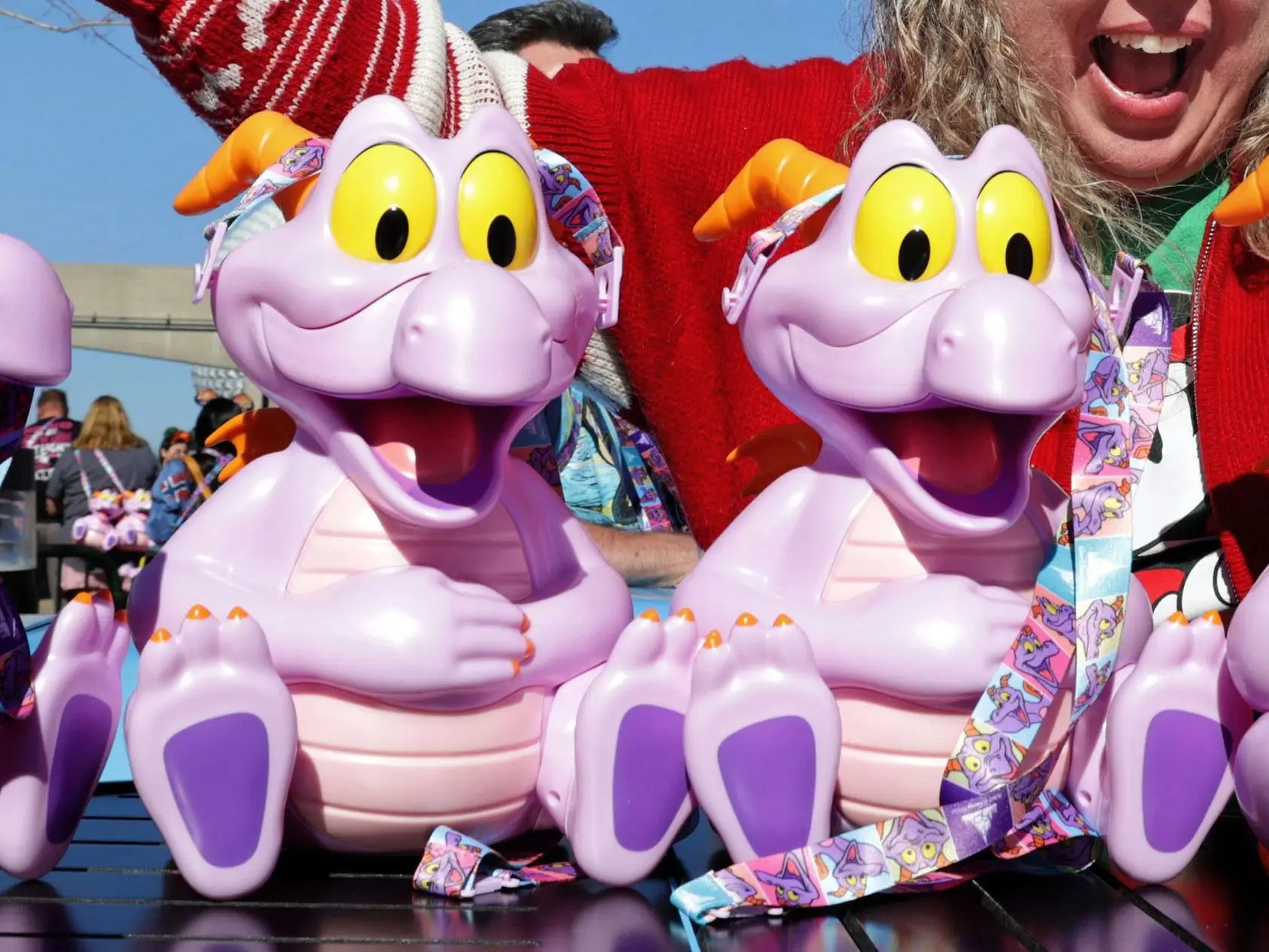 Purple smiling and sitting plastic dinosaur figures.
