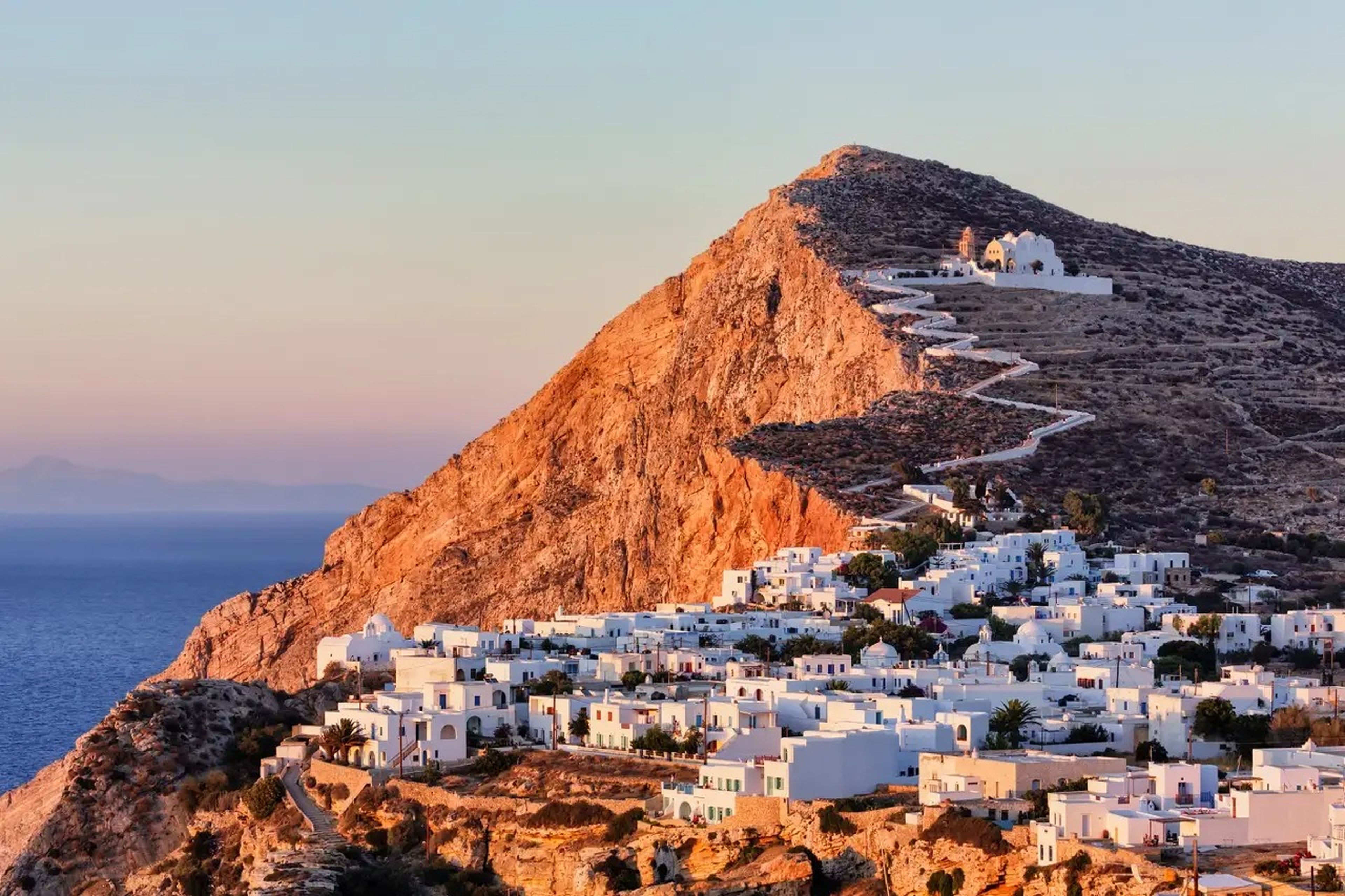 White homes dot the mountainside of the Folegandros island overlooking the Aegan Sea
