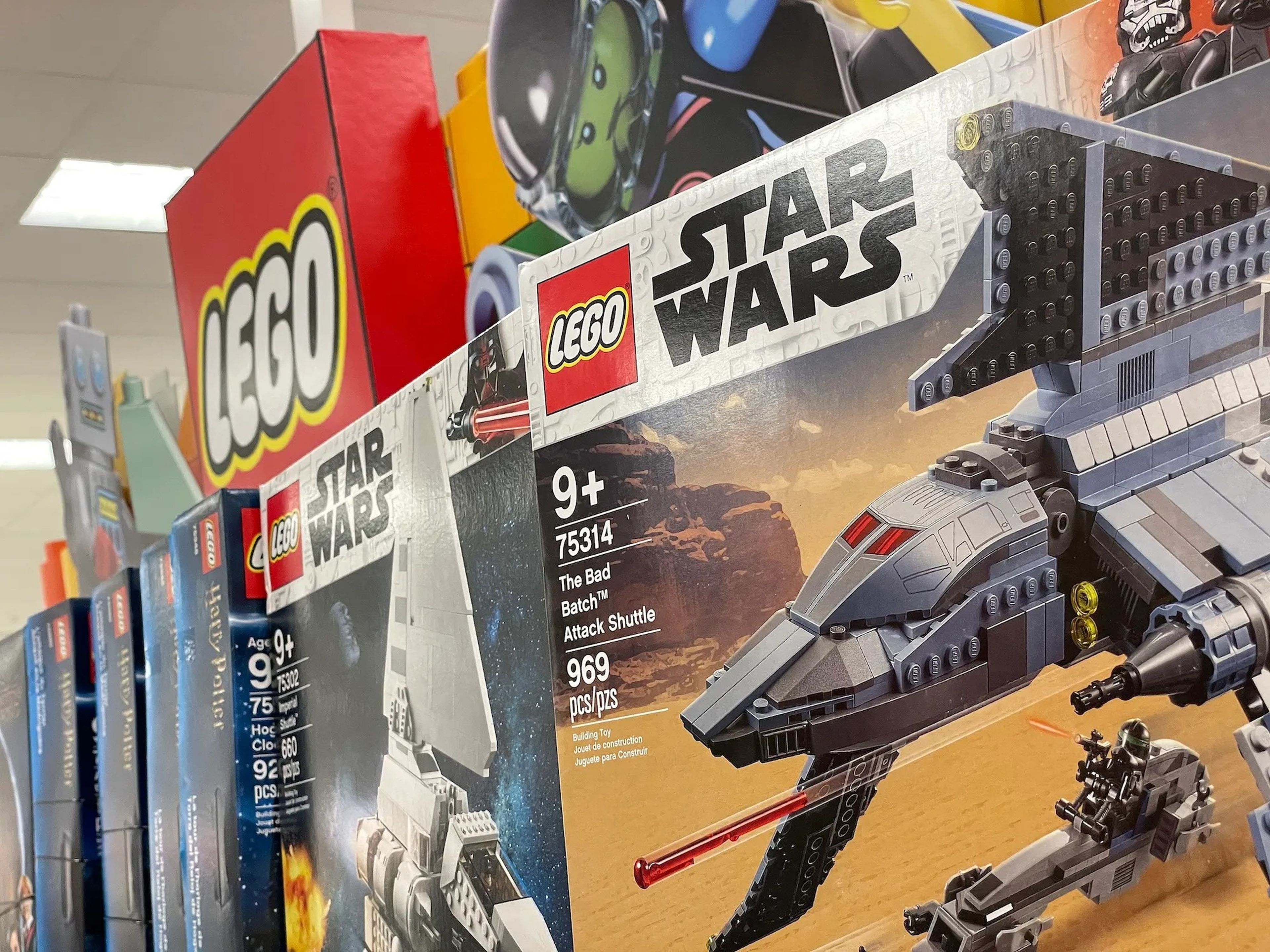 Boxes of Lego sets for sale on a store shelf.