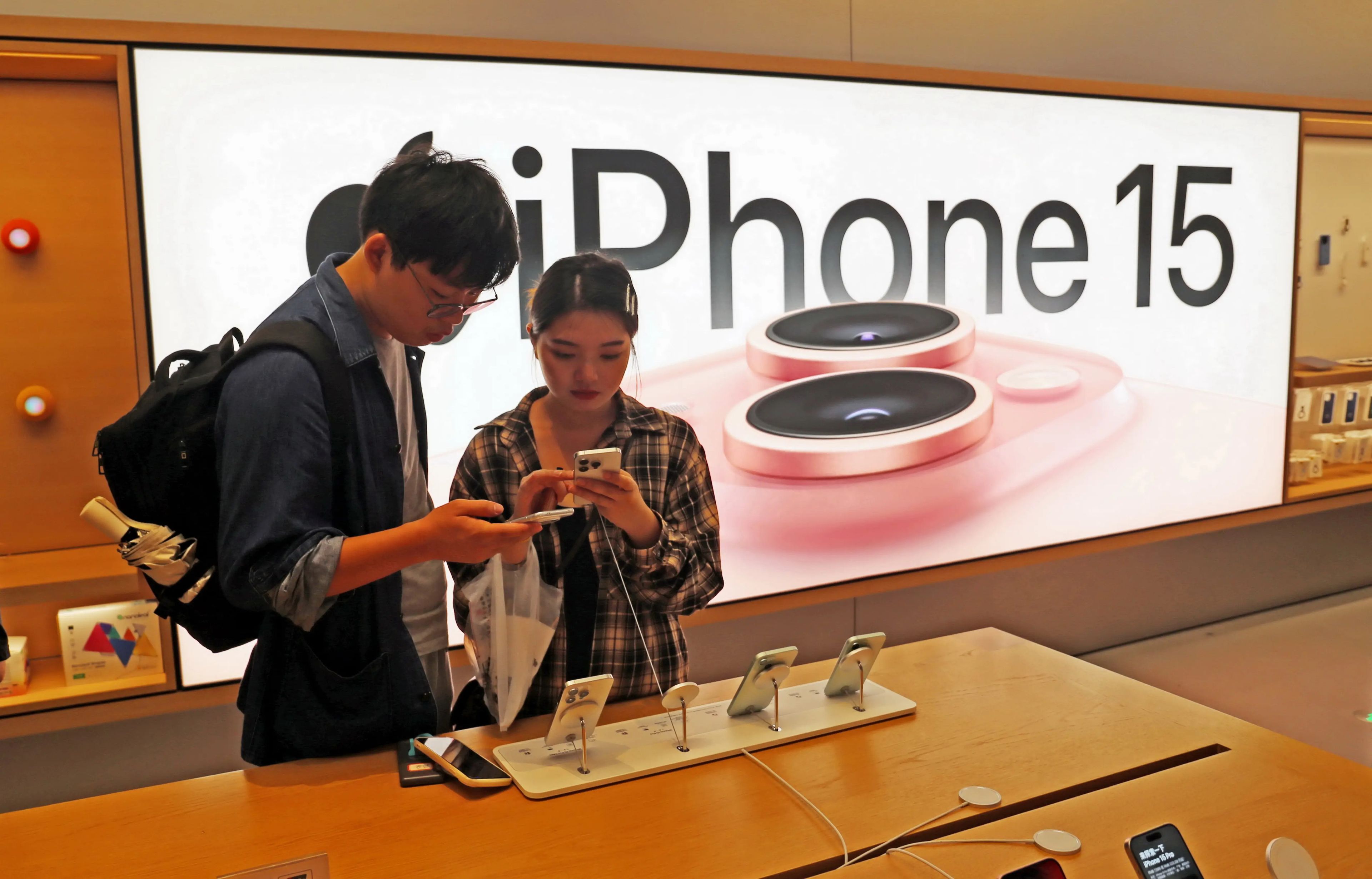 Clientes probando el iPhone 15 de Apple en una tienda Apple de Shanghái, China.