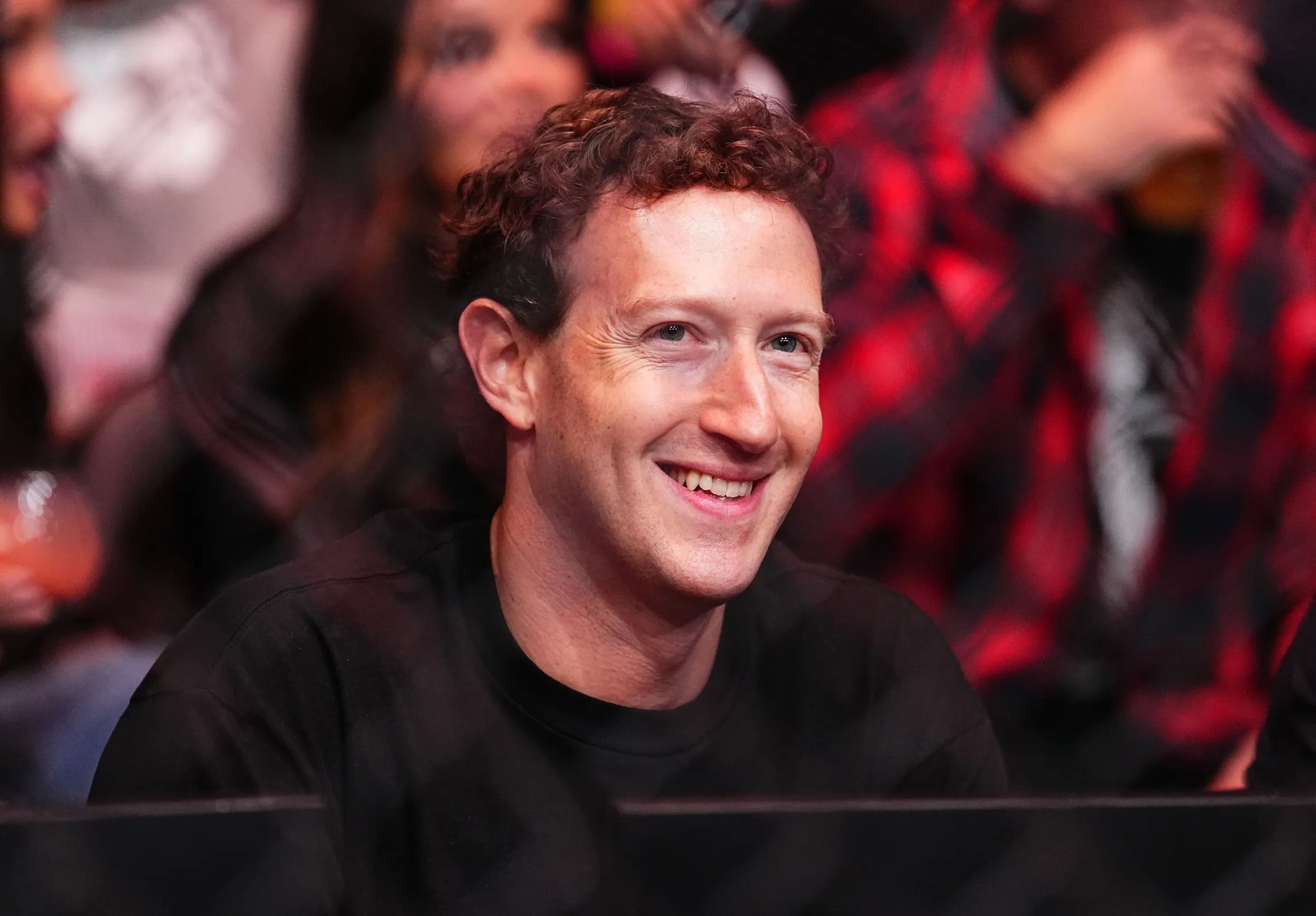 Mark Zuckerberg smiling whilst wearing a black sweatshirt