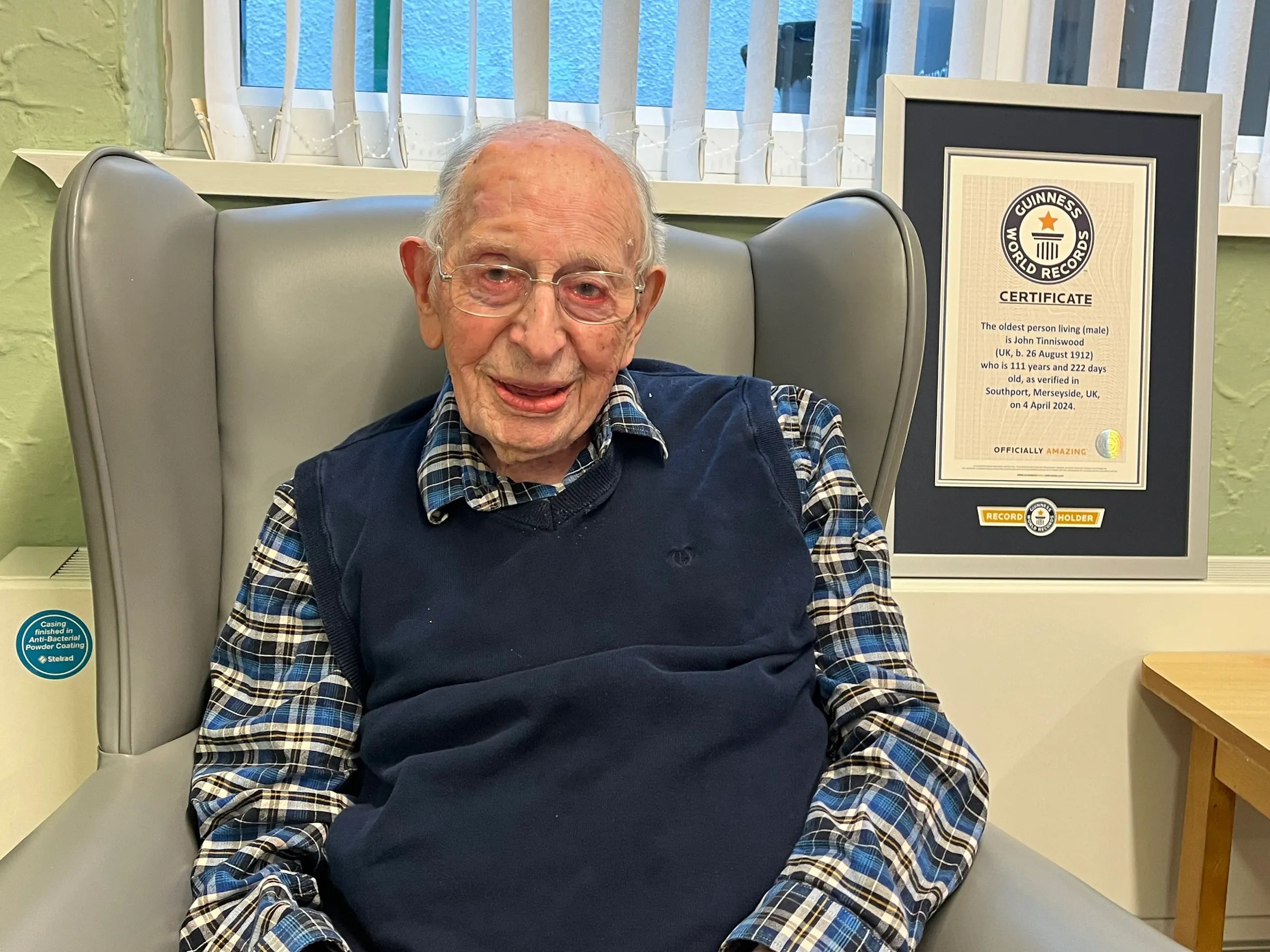 World's oldest man, Jon Tinniswood, with his certificate from Guinness World Records.