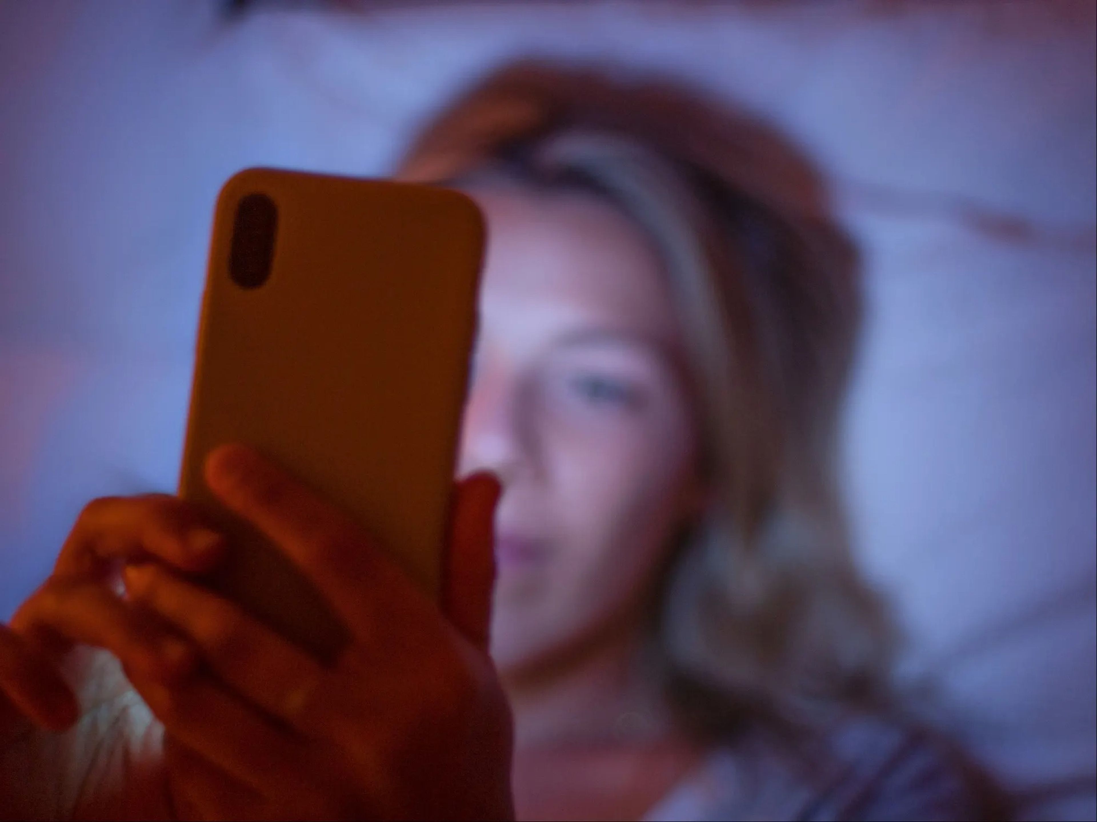 Young woman on phone at night
