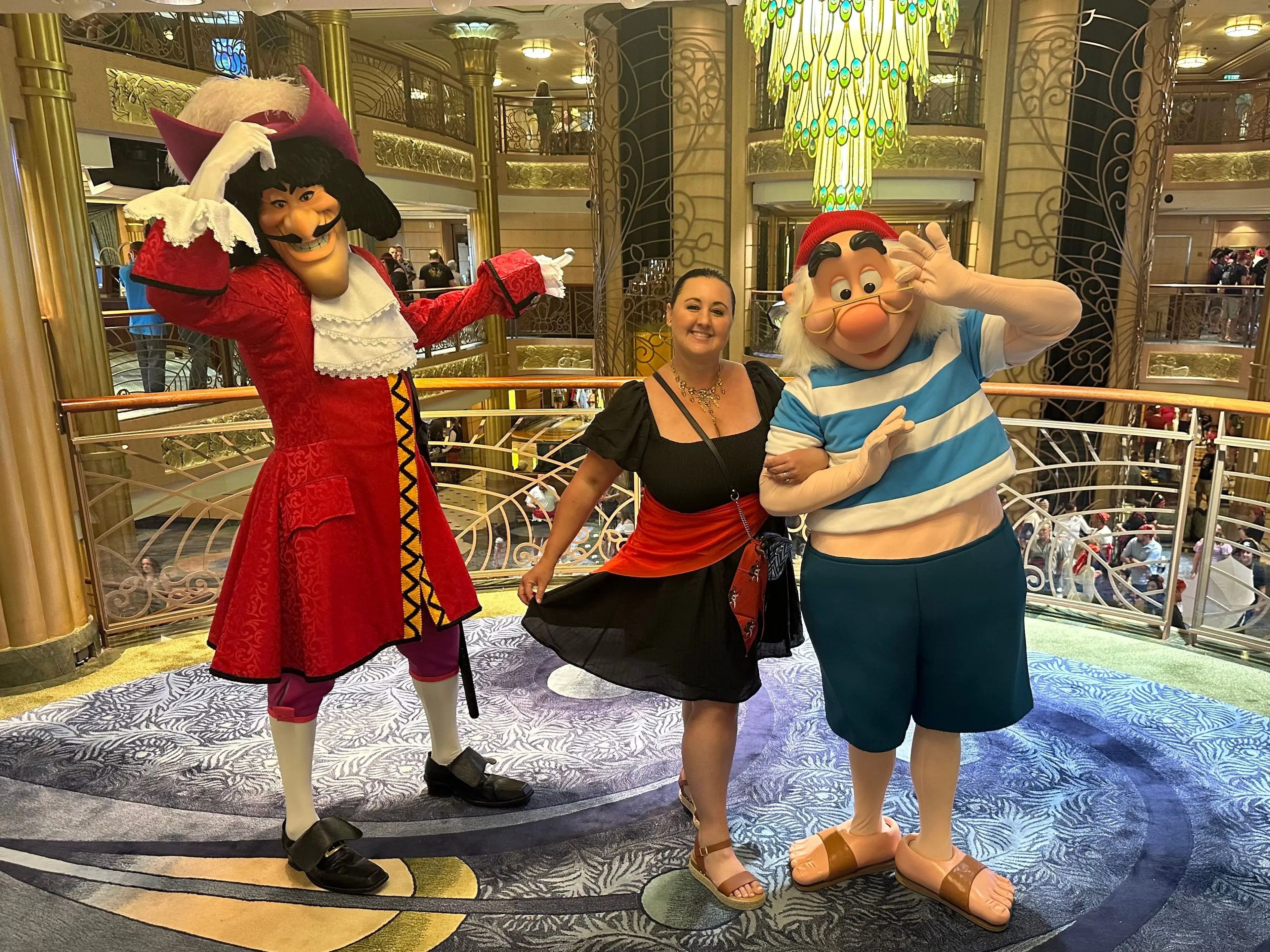 Carly standing between Captain Hook and Smee on a Disney Cruise ship.