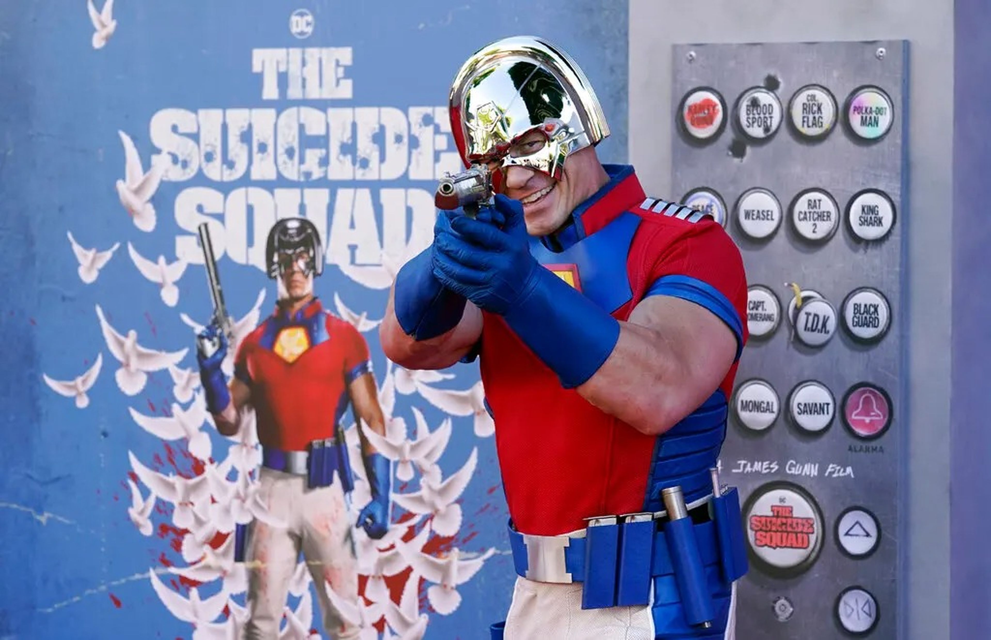 John Cena, a cast member in "The Suicide Squad," poses in front of a poster.