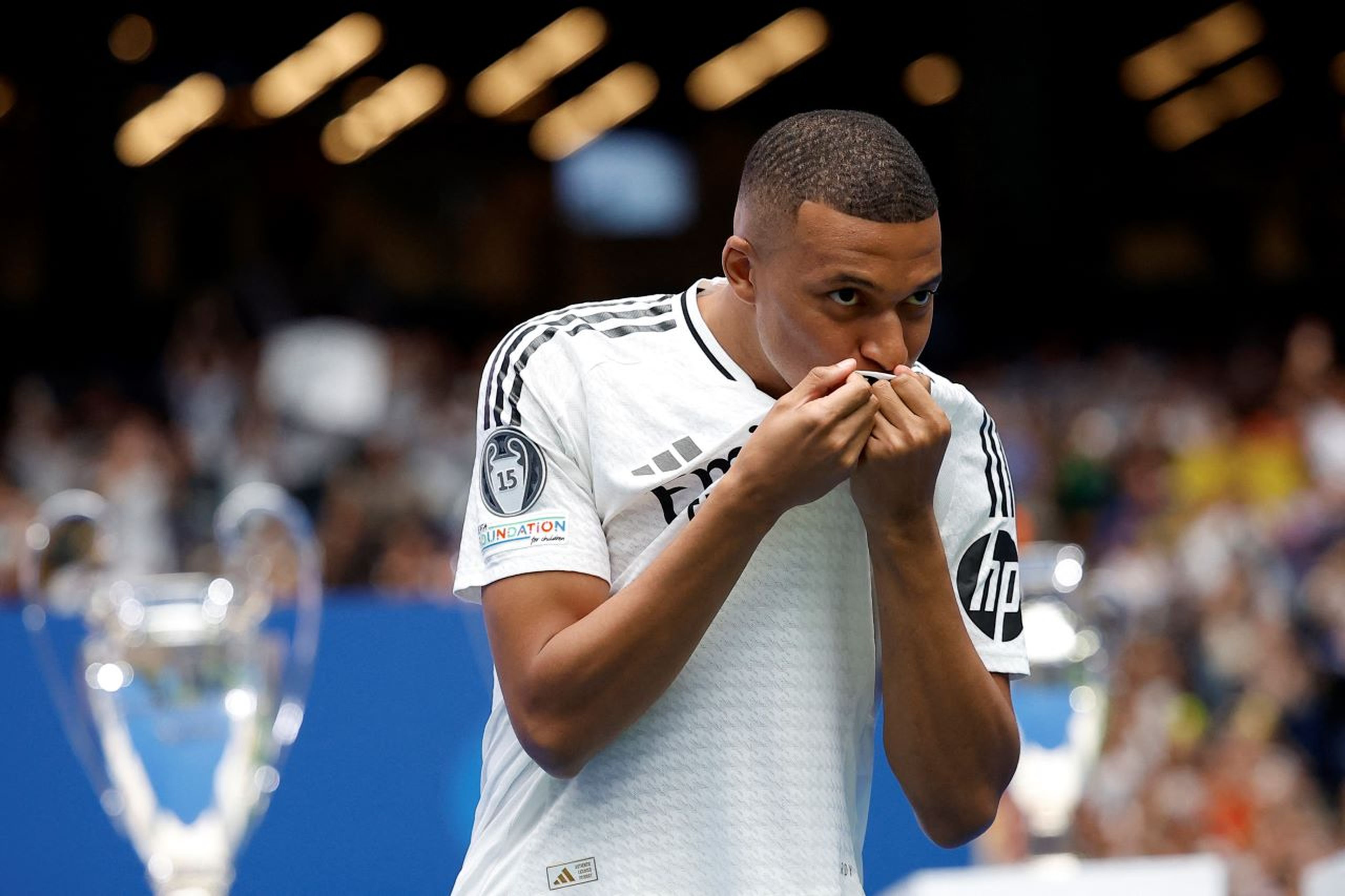 Mbappé besa el escudo del Real Madrid durante su presentación en el Santiago Bernabéu.