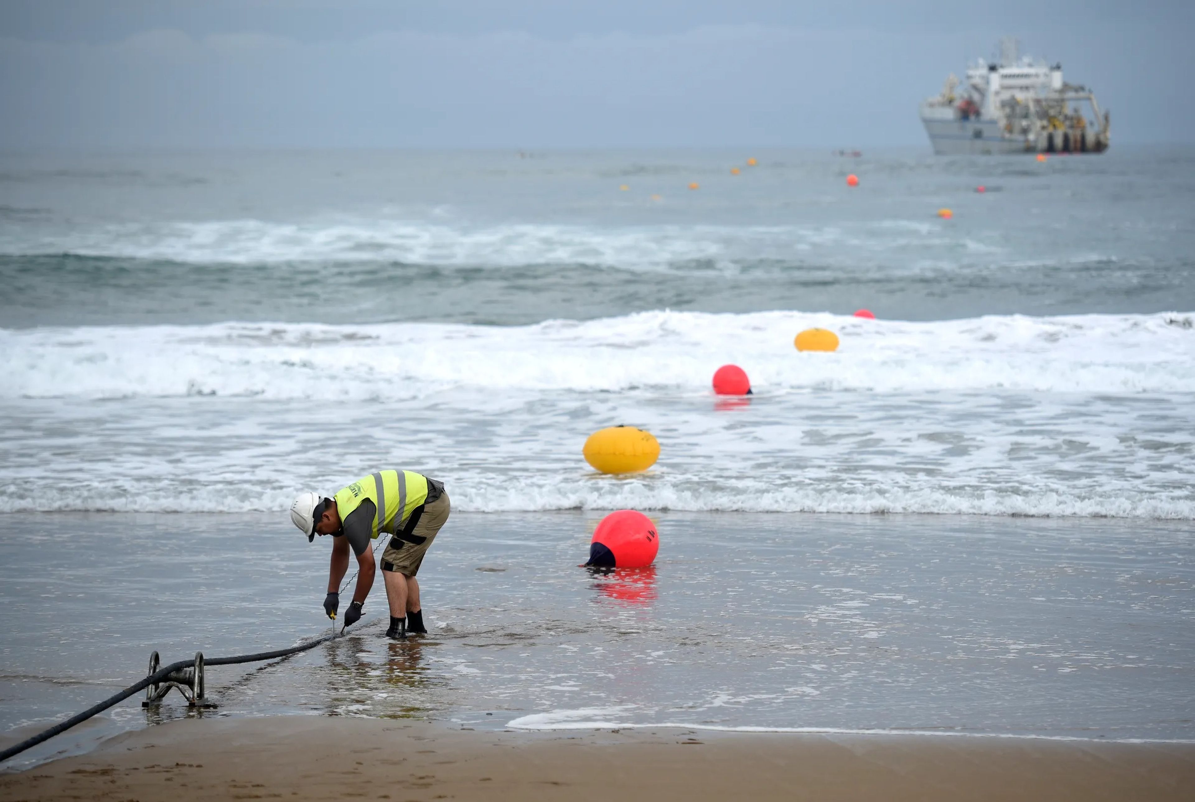 An operator working during the mooring of an undersea fiber optic cable near the Spanish Basque village of Sopelana in 2017.