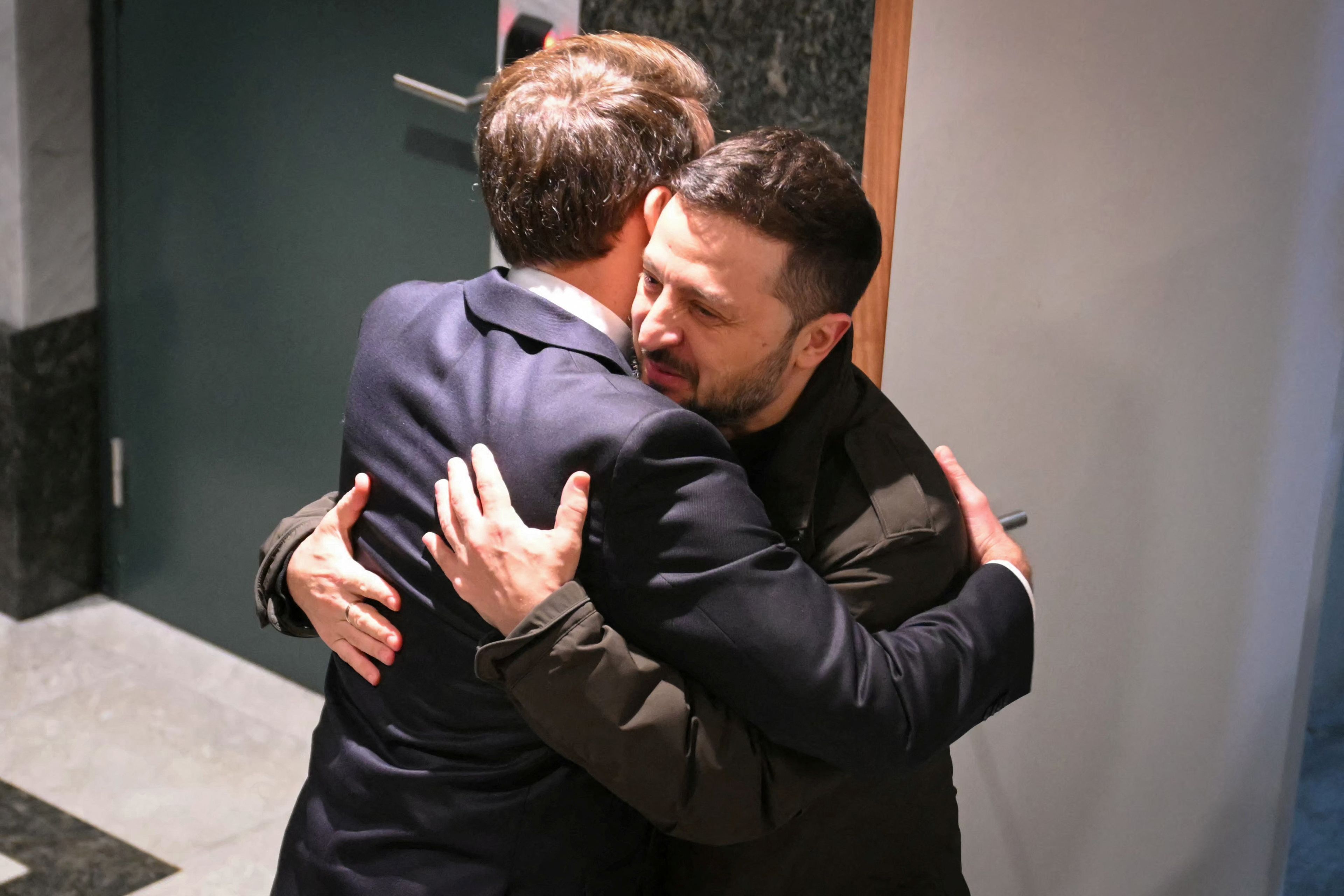 El presidente de Francia, Emmanuel Macron, abraza al presidente de Ucrania, Volodymyr Zelenskiy.