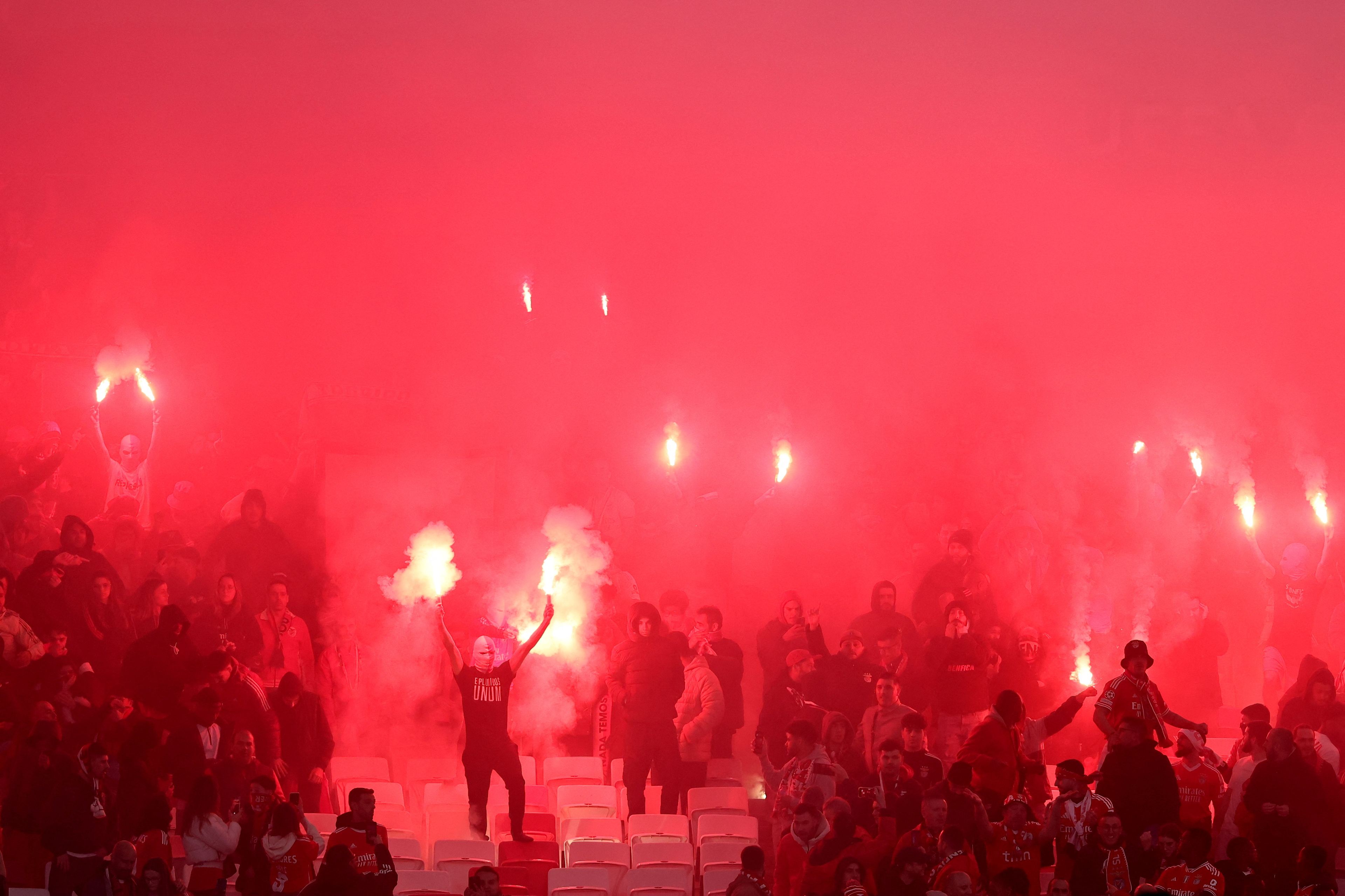 Los aficionados del Benfica lanzan bengalas dentro del estadio durante el partido de Champions entre el Benfica y el FC Barcelona.